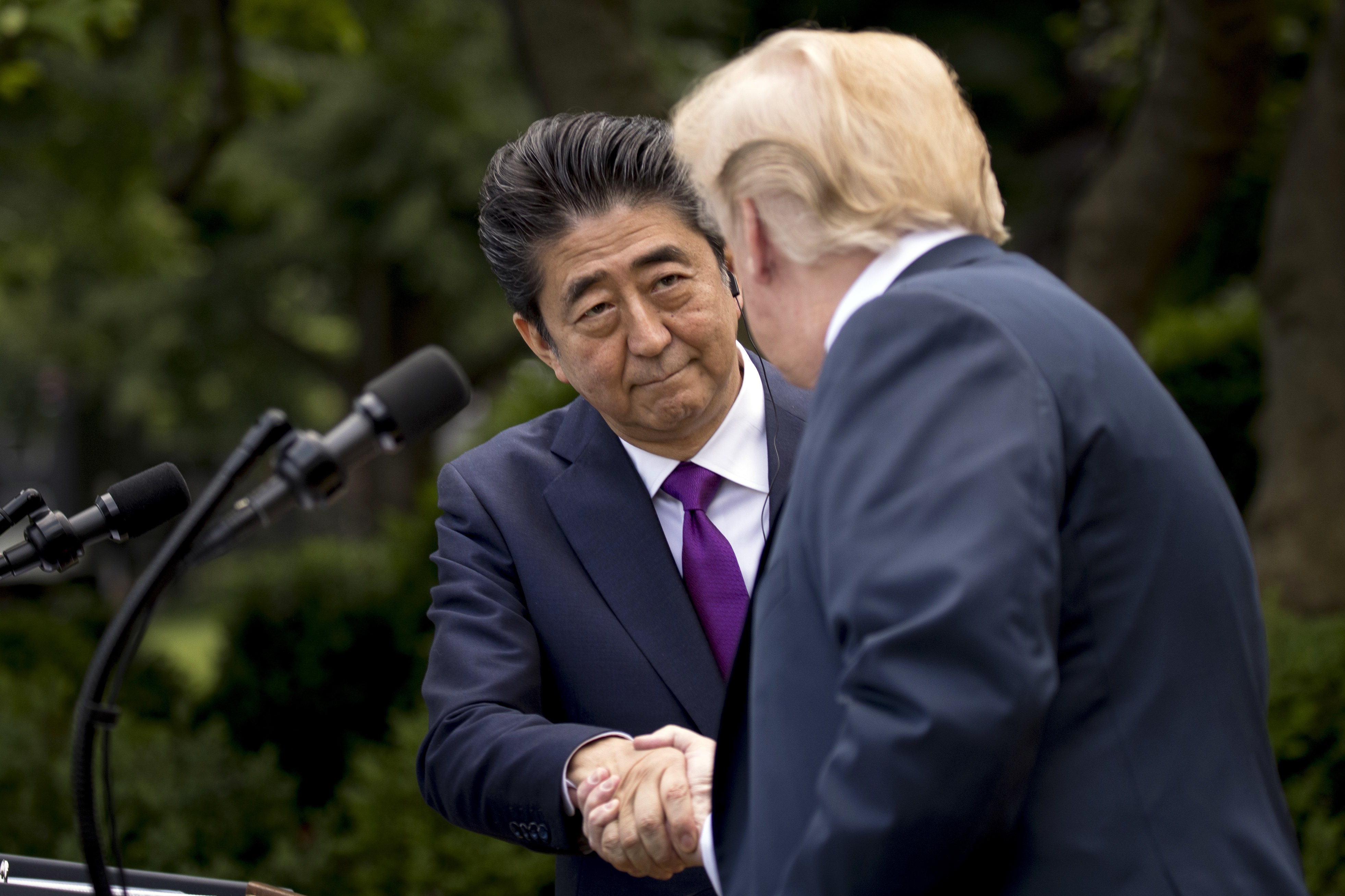 President Donald Trump and Japanese Prime Minister Shinzo Abe shake hands during a news conference in the Rose Garden at the White House, Thursday, June 7, 2018, in Washington. (AP Photo/Andrew Harnik)