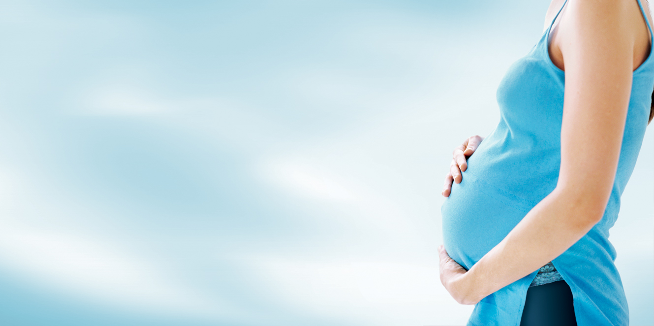 side profile of a pregnant woman touching her abdomen