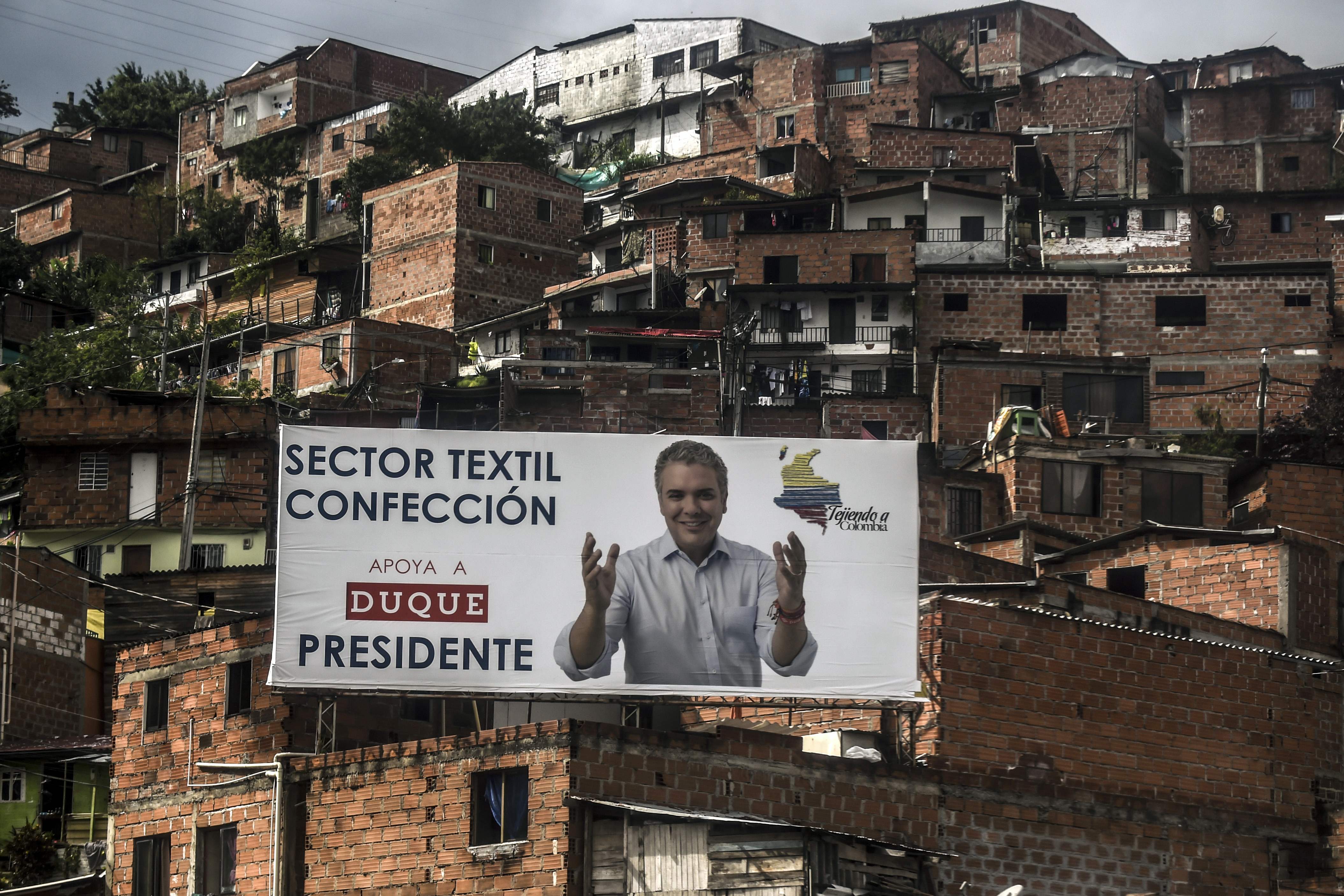 Political advertising for Colombian presidential candidate Ivan Duque of the Centro Democratico party is pictured in Medellin, Colombia on May 23, 2018.
Colombia will hold the first round of the presidential election on May 27, 2018. / AFP PHOTO / JOAQUIN SARMIENTO