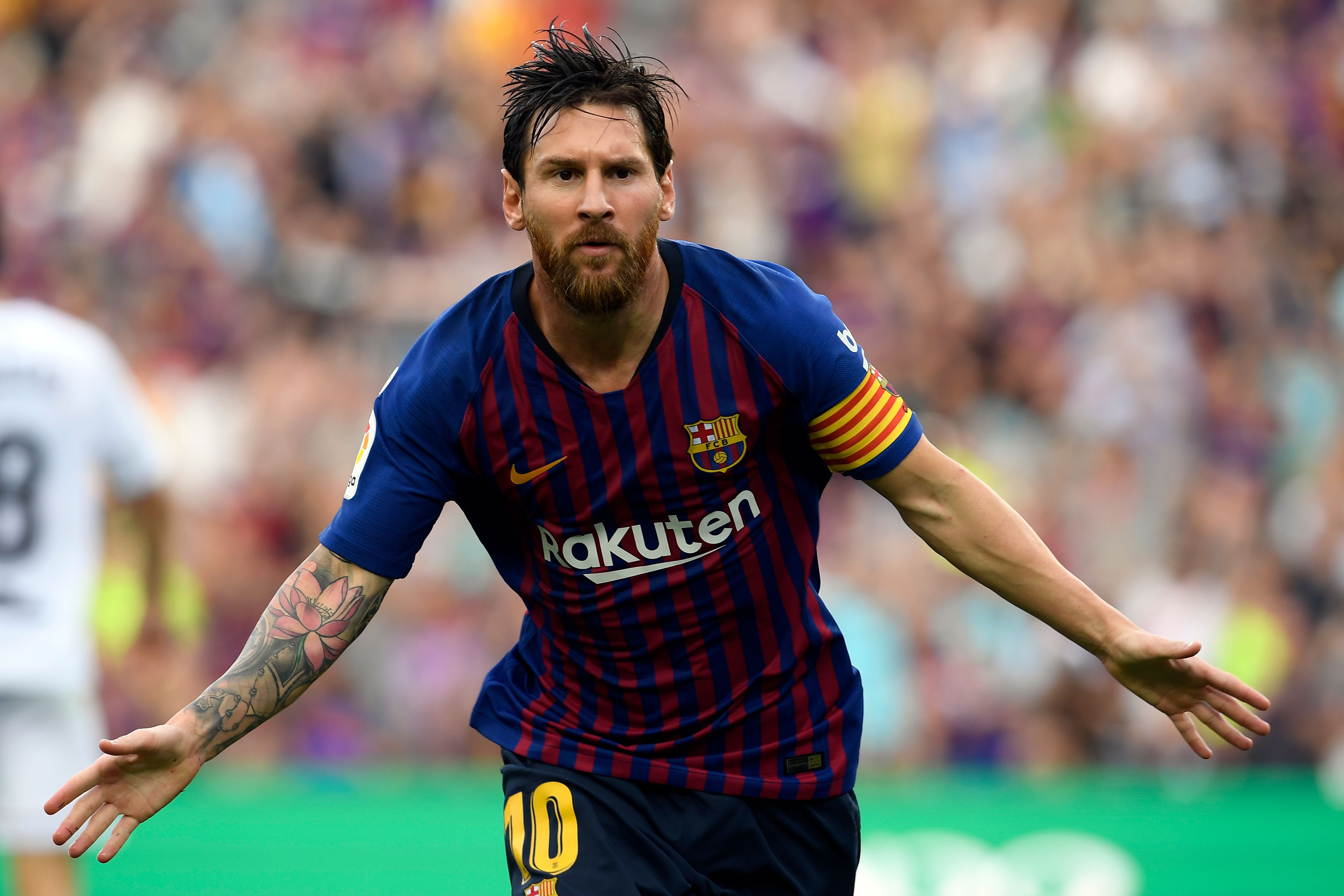 Barcelona's Argentinian forward Lionel Messi celebrates scoring his team's opening goal during the Spanish league football match between FC Barcelona and SD Huesca at the Camp Nou stadium in Barcelona on September 2, 2018. (Photo by LLUIS GENE / AFP)