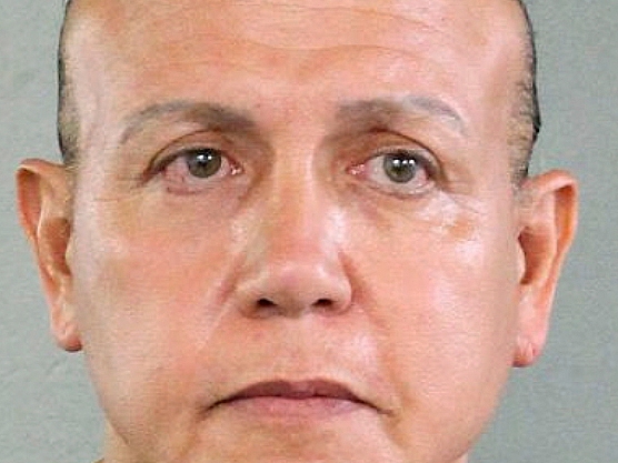 In this undated photo released by the Broward County Sheriff's office, Cesar Sayoc is seen in a booking photo, in Miami. Federal authorities took Sayoc, 56, of Aventura, Fla., into custody Friday, Oct. 26, 2018 in Florida in connection with the mail-bomb scare that earlier widened to 12 suspicious packages, the FBI and Justice Department said. (Broward County Sheriff's Office via AP)