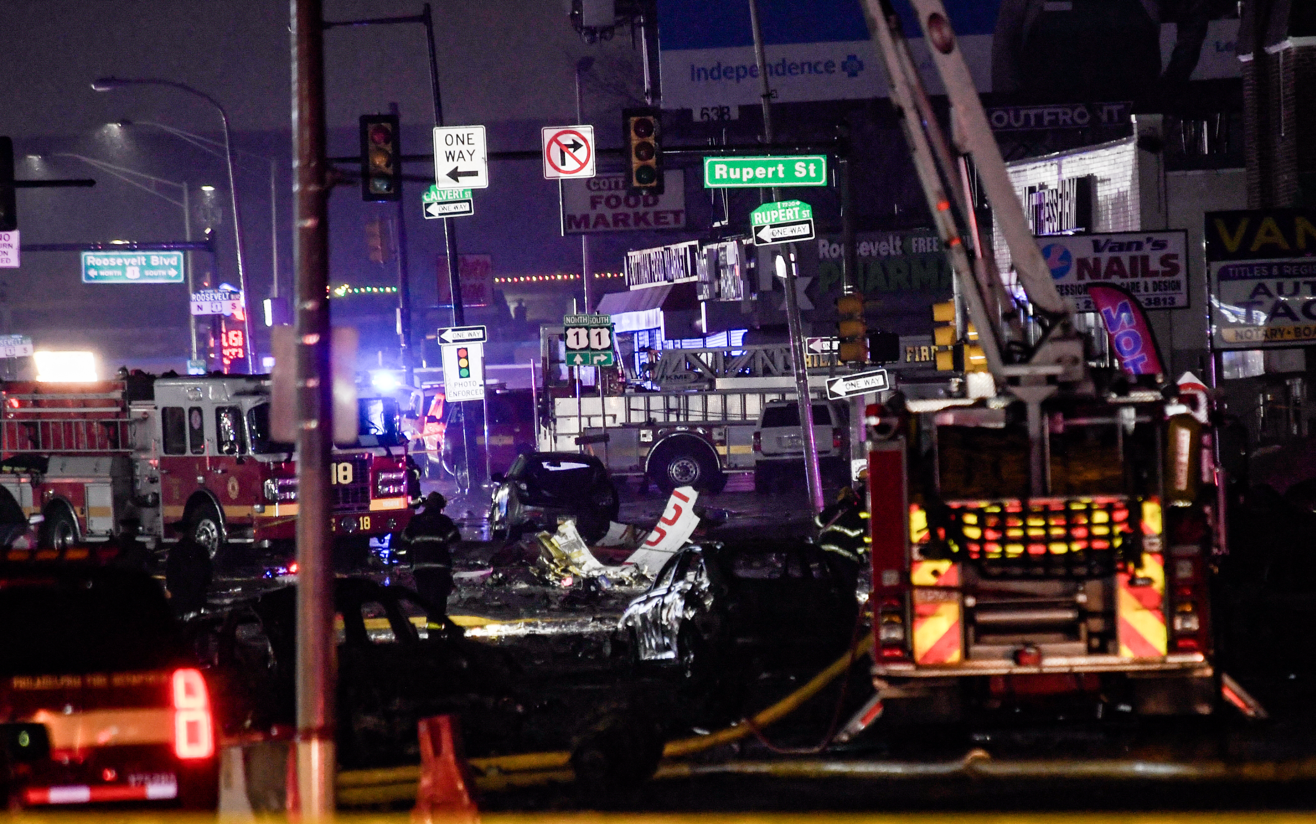 Los miembros del servicio de emergencia responden a un accidente aéreo en un vecindario cerca de Cottman Avenue en Filadelfia, Pensilvania.