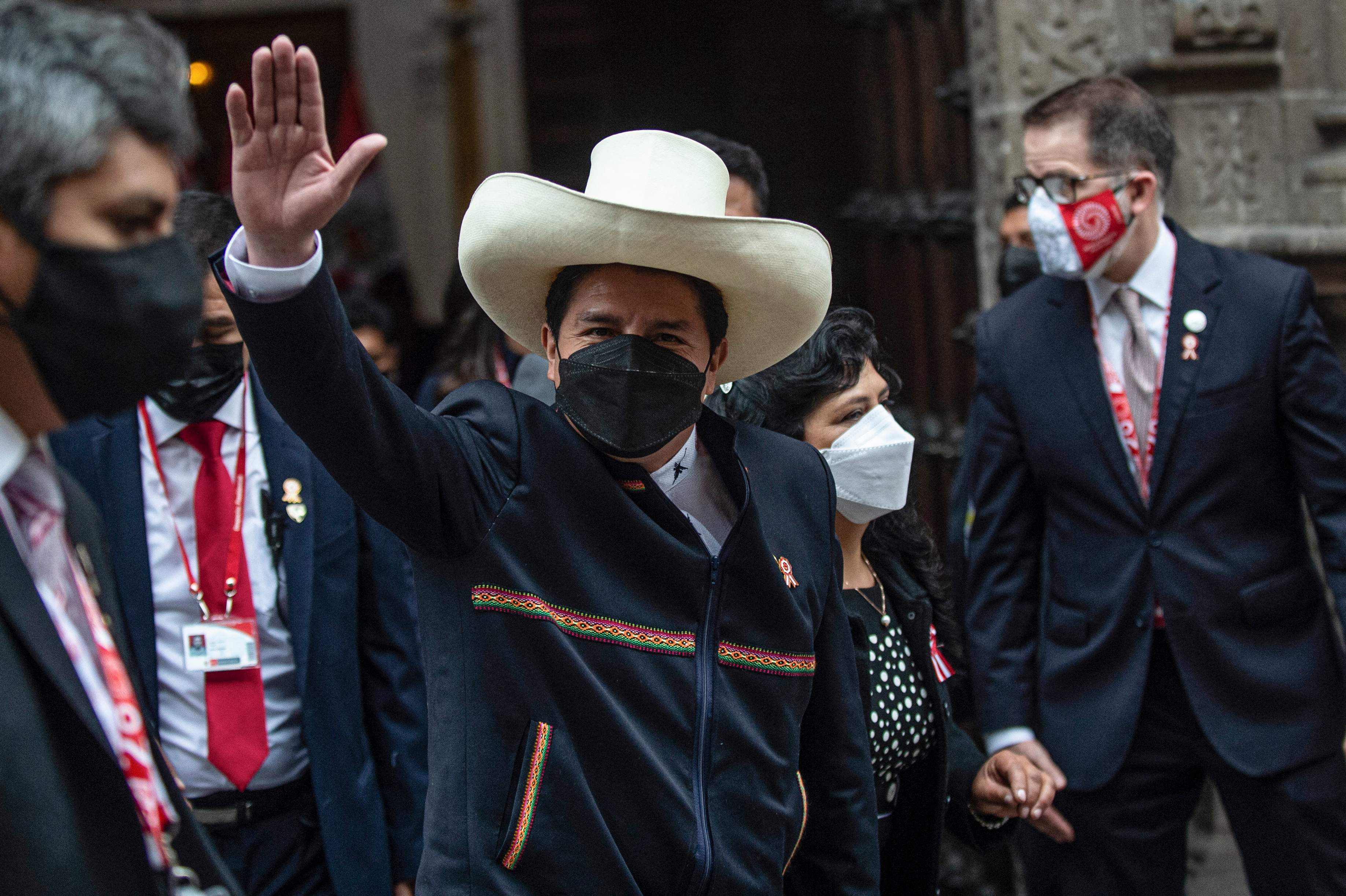 Peru's President-elect Pedro Castillo (C) leaves the Foreign Affairs Minister at Torre Tagle Palace next to his wife Lilia Paredes, before the inauguration ceremony in Lima, on July 28, 2021. - Rural school teacher Pedro Castillo swears in as Peru's president Wednesday with no ties to the elites that have governed the Andean country for decades, and a full inbox: tame the coronavirus epidemic, reactivate a flagging economy, and put paid to years of political turmoil. (Photo by ERNESTO BENAVIDES / AFP)