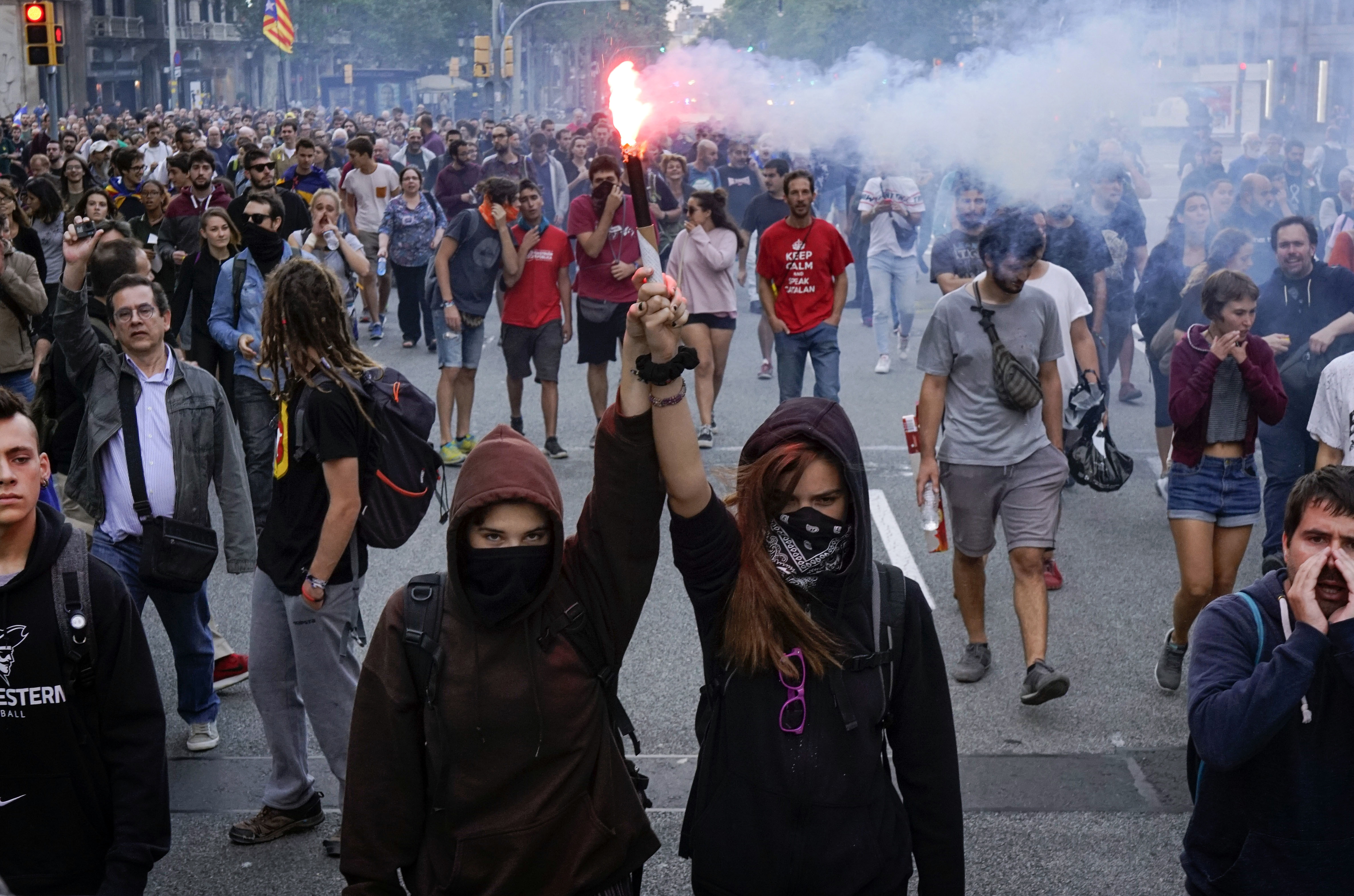 Pro independence demonstrators march during a protest in Barcelona, Spain, on Monday, Oct. 1, 2018. Pro-secession activists in Catalonia have blocked major highways, train lines and avenues across the northeastern region on the anniversary of a banned referendum that was crushed by police and failed to deliver independence from Spain. (AP Photo/Daniel Cole)