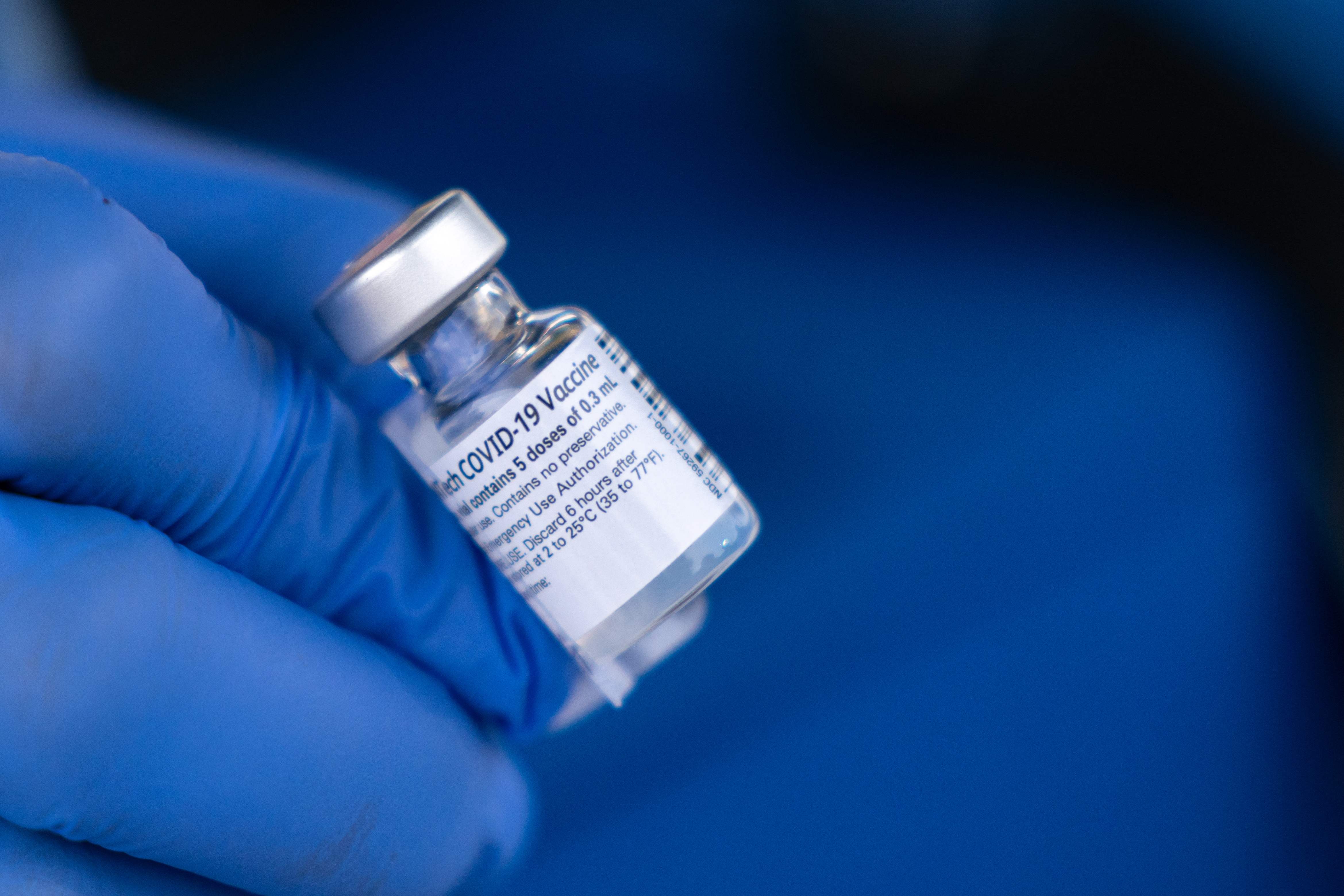 (FILES) In this file photo a nurse shows off a vial of the Pfizer-BioNTech COVID-19 vaccine outside of the Chatham County Health Department on December 15, 2020 in Savannah, Georgia. - Schools in a county in the southeastern US state of Georgia will pay $1,000 bonuses to staff who are vaccinated against Covid-19 in a bid to protect themselves from the resurgent pandemic, authorities said. With that incentive county officials said they hope to avoid the "numerous disruptions that were encountered in public education over the past two school years due to a global pandemic." The Henry county school district, southeast of the city of Atlanta, will make a $1,000 payment to those of its nearly 6,000 employees who are fully vaccinated now or who will be vaccinated by September 30, 2021 with one dose of Johnson & Johnson's vaccine or both doses from Pfizer or Moderna. (Photo by Sean Rayford / GETTY IMAGES NORTH AMERICA / AFP)