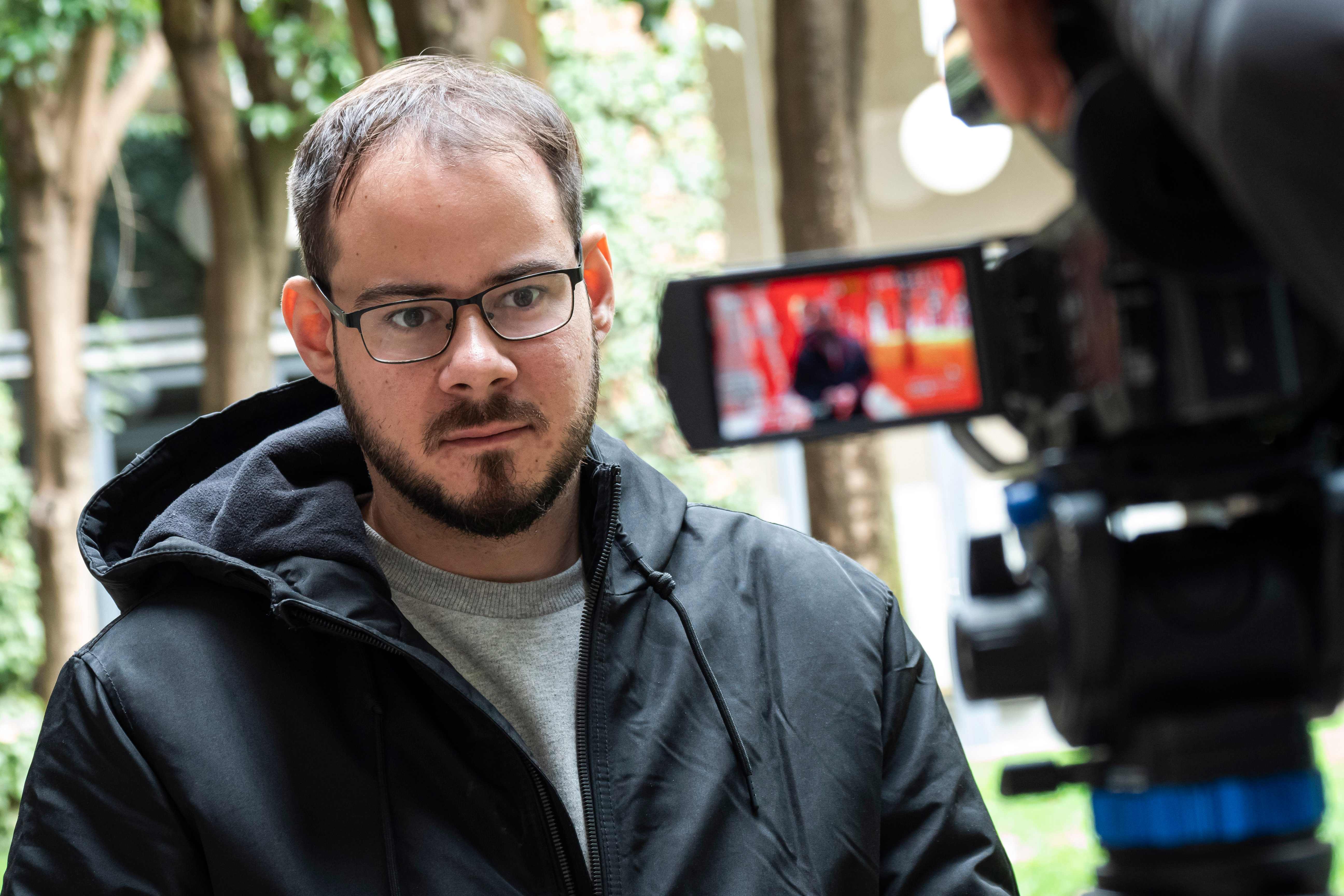 Spanish rapper Pablo Hasel speaks to the press at the University of Lleida, 150 kms (90 miles) west of Barcelona, on February 15, 2021 after barricading himself inside the campus. - Hasel, who was due to begin a controversial nine-month jail sentence over a string of Tweets, barricaded himself inside the Catalan university to avoid arrest. (Photo by J. Martin / AFP)