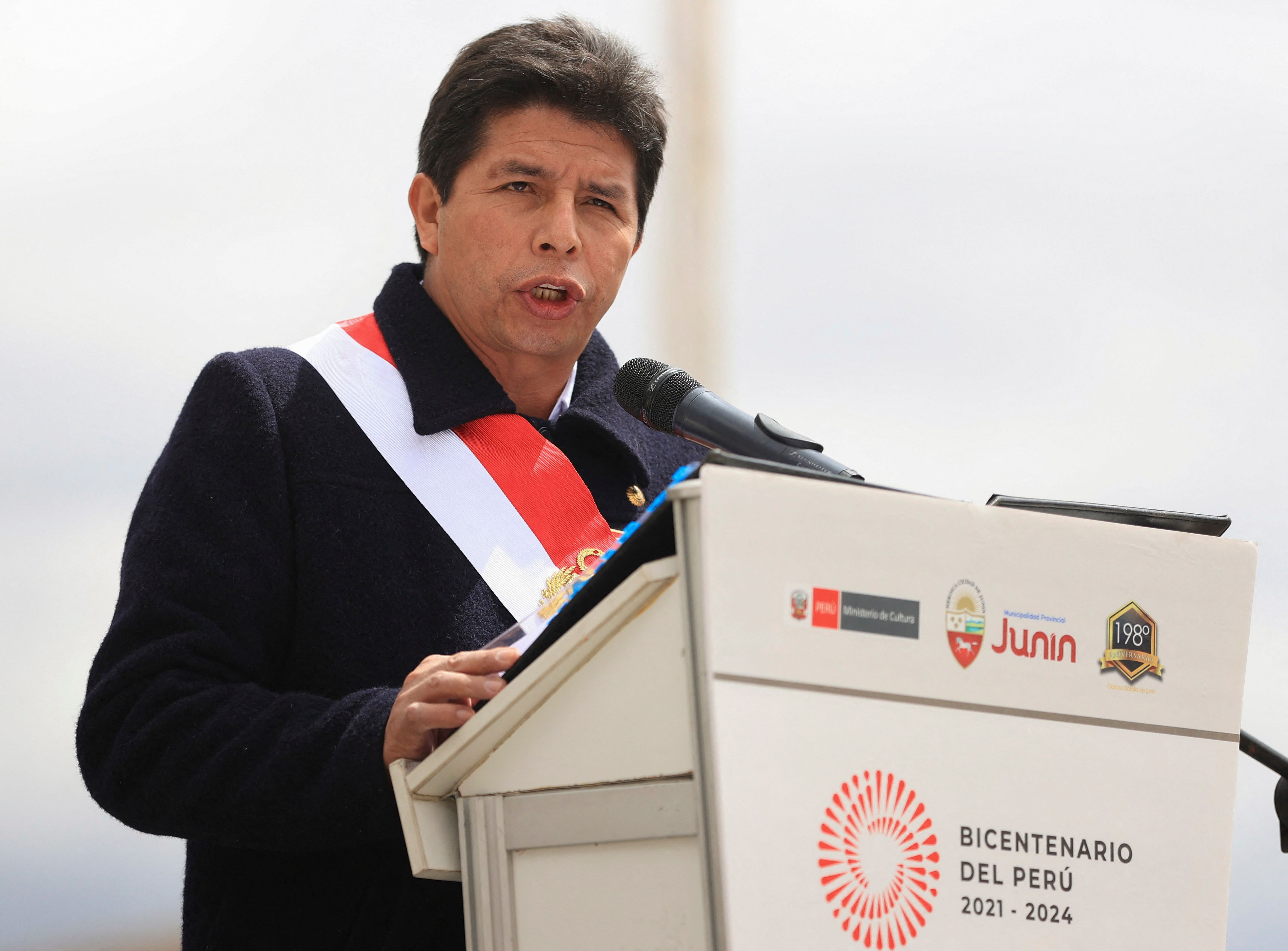 Handout picture released by Peruvian news agency Andina showing President Pedro Castillo delivering a speech during a ceremony to commemorate the 198th anniversary of the Battle of Junin, in Junin, in the Peruvian Andes, on August 6, 2022. - Castillo said he is reaching out to the political forces of Congress "for the last time", before being forced to make a national crusade to "defend democracy" in his country. Leftist Castillo -- a rural school teacher who unexpectedly took power from Peru's traditional political elite in elections last year -- faces five criminal investigations into claims of graft and plagiarizing his university thesis. (Photo by Jhonel RODRIGUEZ / ANDINA / AFP) / RESTRICTED TO EDITORIAL USE - MANDATORY CREDIT "AFP PHOTO / ANDINA / JHONEL RODRIGUEZ" - NO MARKETING - NO ADVERTISING CAMPAIGNS - DISTRIBUTED AS A SERVICE TO CLIENTS