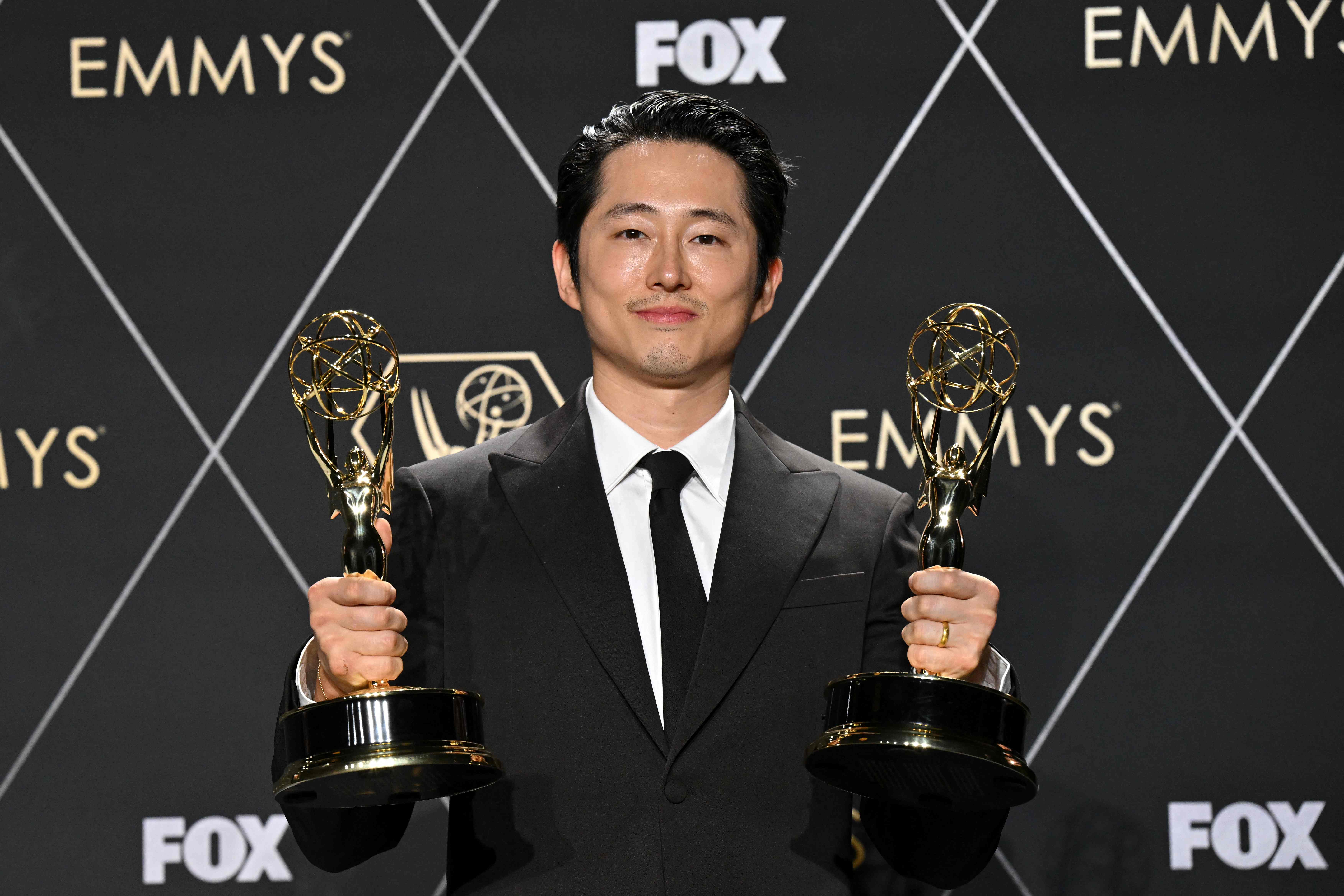 US actor Steven Yeun, winner of Outstanding Lead Actor In A Limited Or Anthology Series Or Movie and Outstanding Limited Or Anthology Series for "Beef," poses in the press room during the 75th Emmy Awards at the Peacock Theatre at L.A. Live in Los Angeles on January 15, 2024. (Photo by Robyn BECK / AFP)