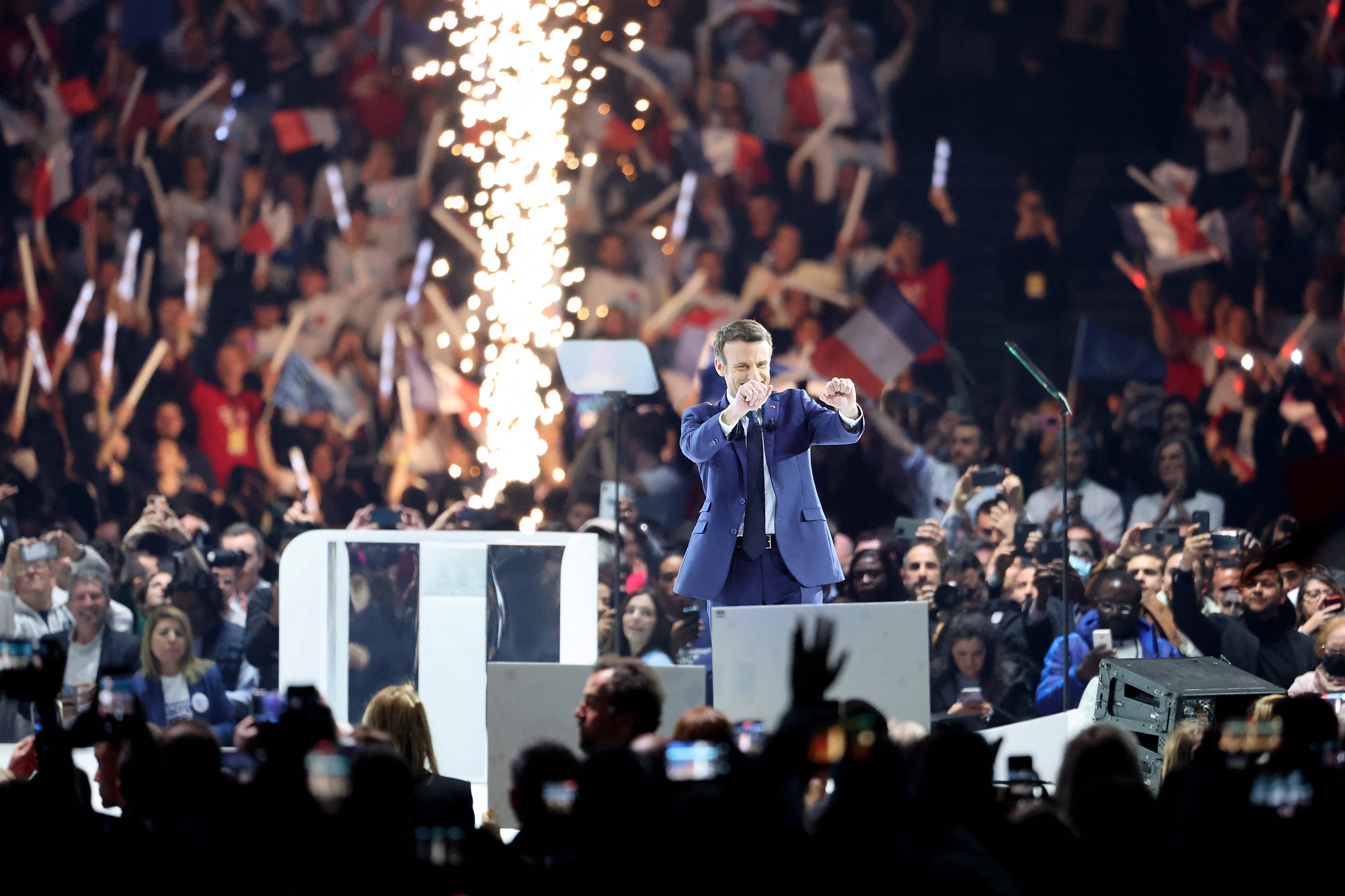 French President and liberal party La Republique en Marche (LREM) candidate for re-election Emmanuel Macron greets his supporters during his first campaign meeting at the Paris La Defense Arena, in Nanterre, on the outskirts of Paris, on April 2, 2022. (Photo by Thomas COEX / AFP)