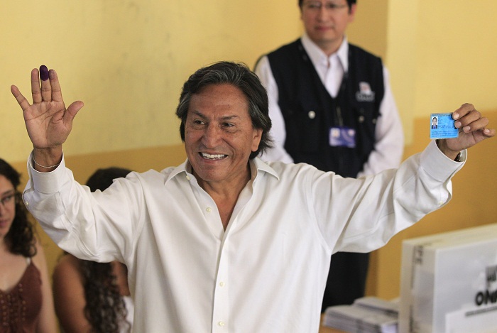 FILE -- In this April 10, 2011 file photo, then presidential candidate Alejandro Toledo holds up his ink-stained finger and identification card after voting in the general elections, in Lima, Peru. Israeli authorities say that they will not permit Peru's fugitive former president to enter the country if he attempts to do so. In a statement, Israel's Foreign Ministry said Sunday, Feb. 12, 2017, that Alejandro Toledo will be allowed into Israel once "once his affairs in Peru are settled." Toledo, who is accused of taking some $20 million in bribes, was believed to be in San Francisco over the weekend and possibly on a flight set to land in Israel later Sunday. (AP Photo/Martin Mejia, File)