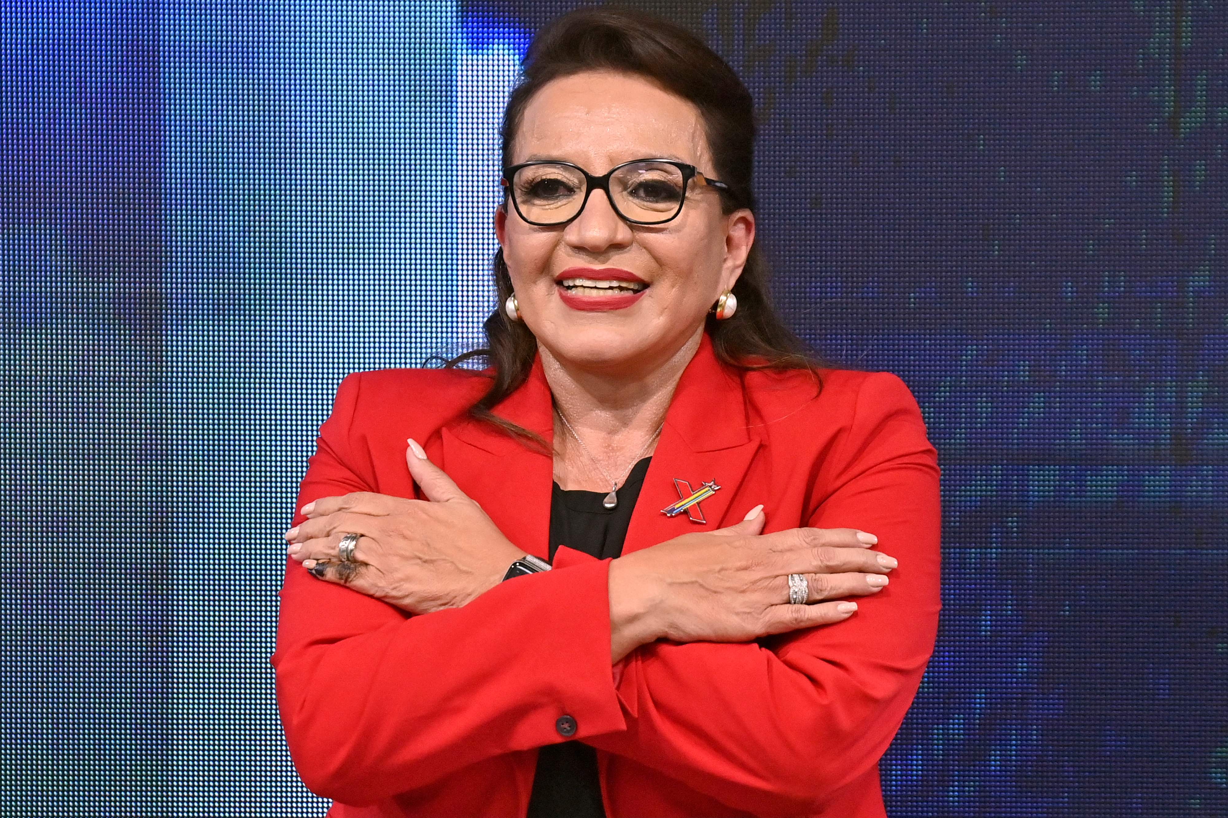 Honduran presidential candidate for the Libertad y Refundacion (LIBRE) party, Xiomara Castro, reacts at the party's headquarters after general elections in Tegucigalpa, on November 28, 2021. - Opposition candidate Xiomara Castro took a commanding lead over the ruling party candidate Nasry Asfura in preliminary results announced following Sunday's presidential election. With 16 percent of the vote count completed, former first lady Castro had almost 53.5 percent of the vote with the National Party's Asfura a distant second out of 13 candidates on 34 percent. (Photo by Luis ACOSTA / AFP)