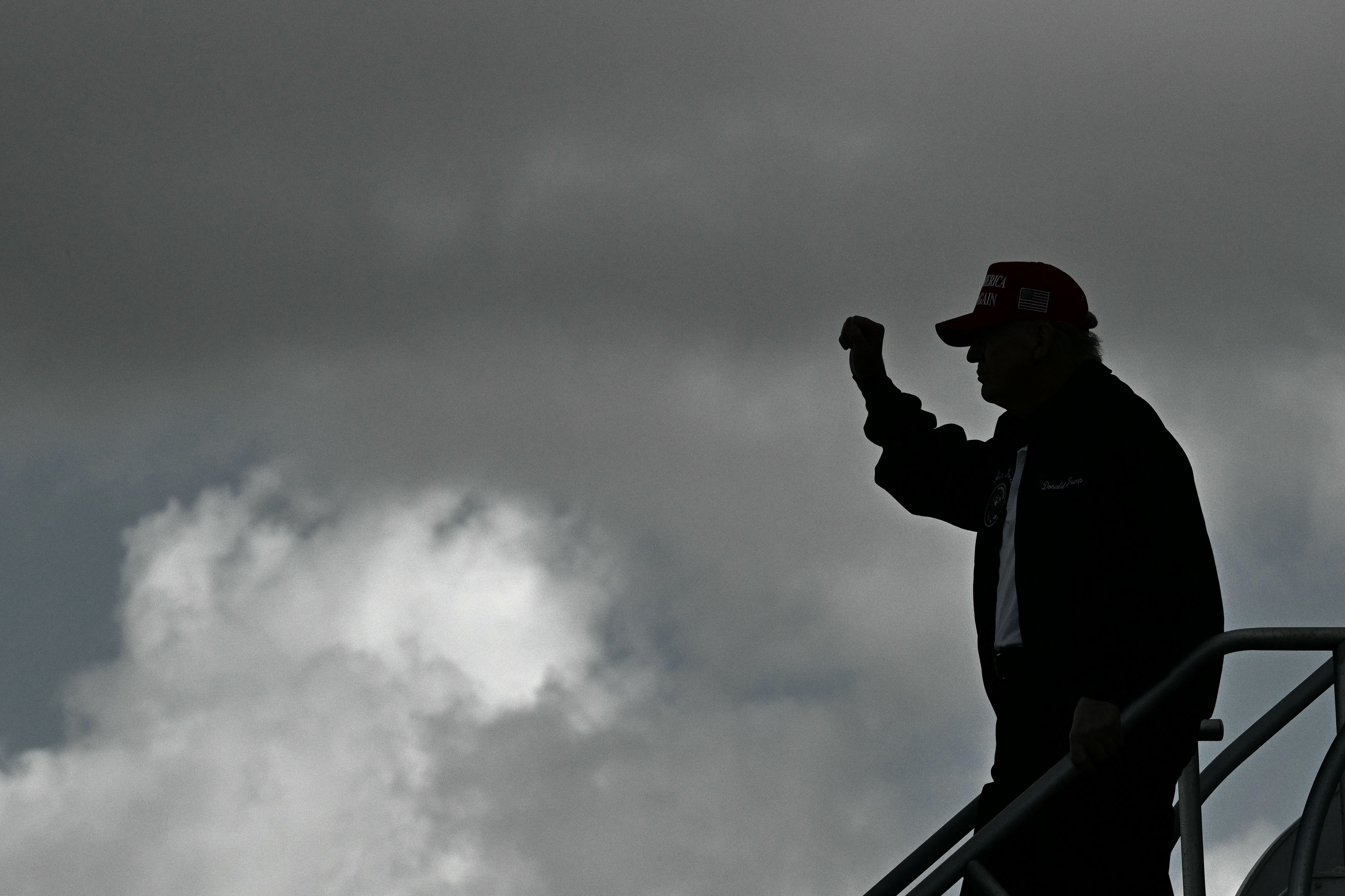 (FILES) US President Donald Trump steps off Air Force One upon arrival at Miami International Airport in Miami, Florida on February 19, 2025. With Donald Trump back in the White House you never know what you're going to get. Will he berate a foreign leader? Rock the global markets? Take vengeance against his foes? But there has been one constant behind the chaos of his first 100 days -- Trump is pushing US presidential power to almost imperial limits. (Photo by ROBERTO SCHMIDT / AFP)
