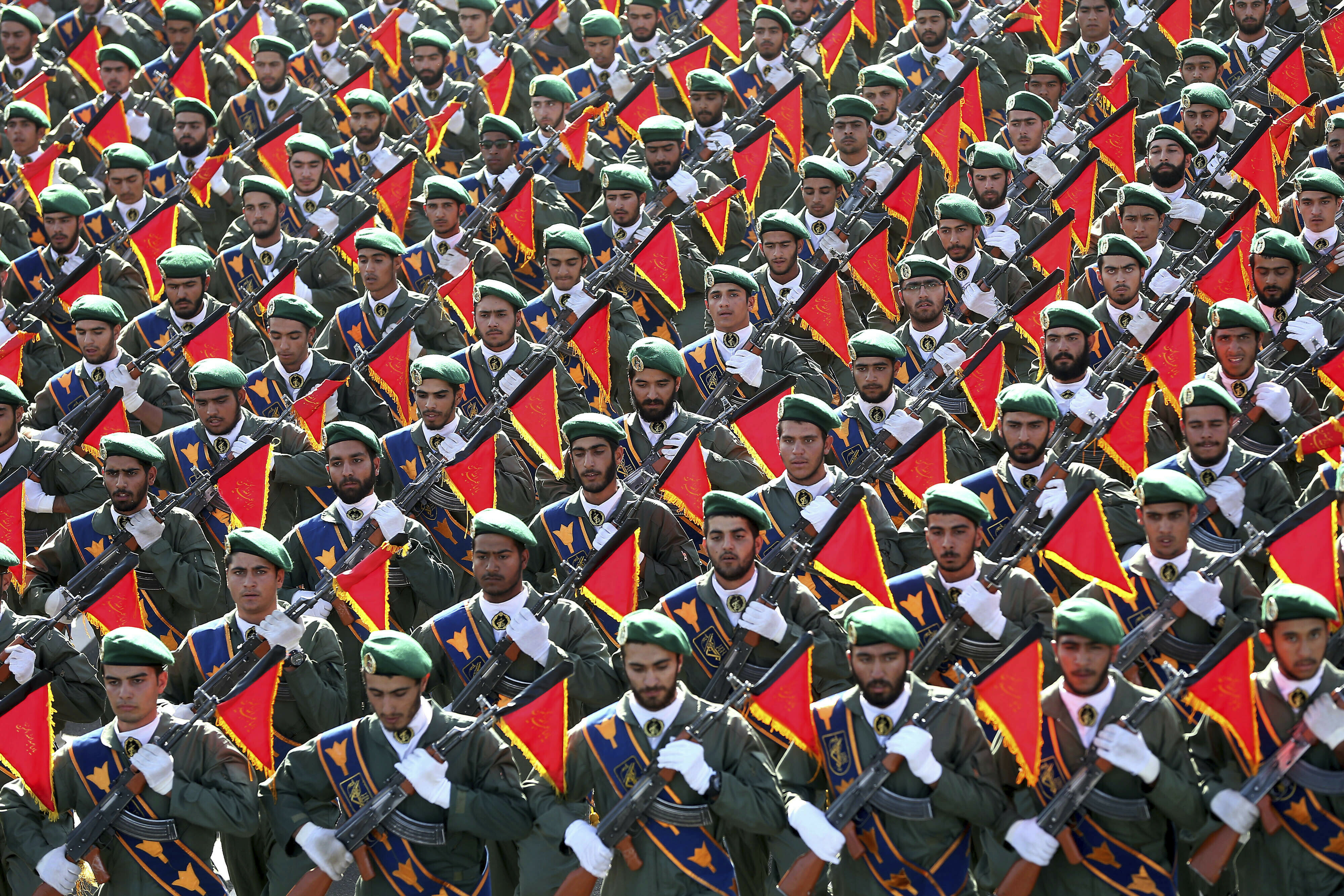 FILE - In this Sept. 21, 2016 file photo, Iran's Revolutionary Guard troops march in a military parade marking the 36th anniversary of Iraq's 1980 invasion of Iran, in front of the shrine of late revolutionary founder Ayatollah Khomeini, just outside Tehran, Iran. The Trump administration is preparing to designate Iran’s Revolutionary Guards Corps a “foreign terrorist organization” in an unprecedented move that could have widespread implications for U.S. personnel and policy. U.S. Officials say an announcement could come as early as Monday, April 8, 2019, following a months-long escalation in the administration’s rhetoric against Iran. The move would be the first such designation by any U.S. administration of an entire foreign government entity. (AP Photo/Ebrahim Noroozi, File)