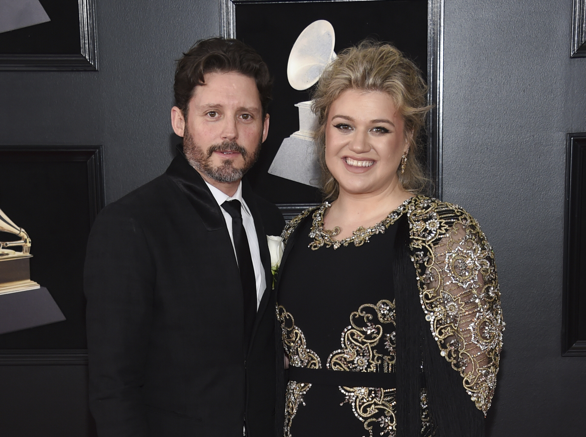 FILE - In this Jan. 28, 2018 file photo shows Kelly Clarkson and her husband Brandon Blackstock at the 60th annual Grammy Awards in New York. Clarkson has filed for divorce from her husband of nearly seven years. The singer, talk show host and judge filed court papers on June 4 in Los Angeles. The 38-year-old Clarkson and the 43-year-old Blackstock have a 5-year-old daughter and a 4-year-old son. (Photo by Evan Agostini/Invision/AP, File)