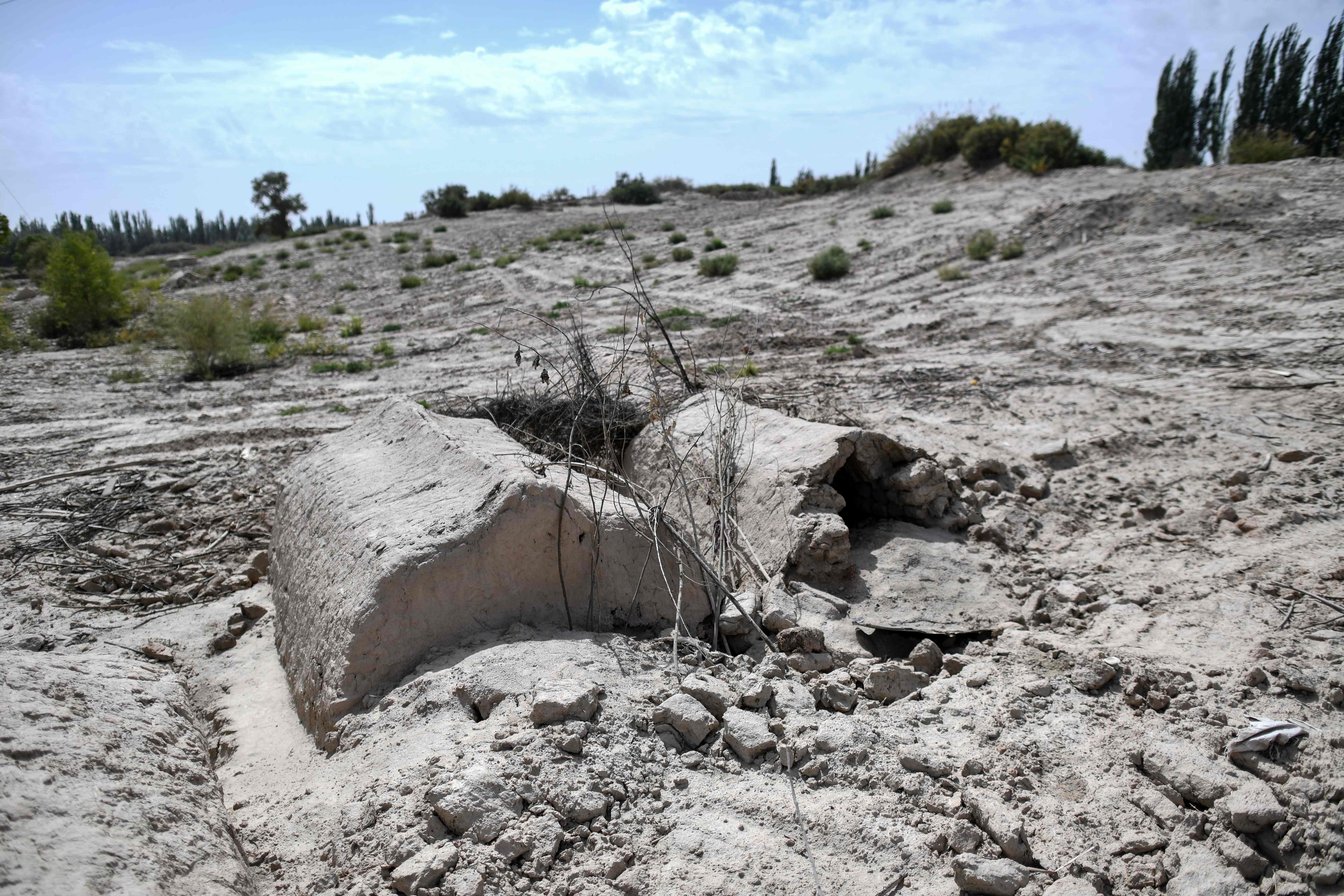 This photo taken on September 12, 2019 shows a general view of what used to be a traditional Uighur cemetery before it was destroyed in Shayar in the region of Xinjiang. - China is destroying burial grounds where generations of Uighur families have been laid to rest, leaving behind human bones and broken tombs in what activists call an effort to eradicate the ethnic group's identity in Xinjiang. (Photo by HECTOR RETAMAL / AFP) / TO GO WITH China-rights-Xinjiang,FEATURE by Eva Xiao, Pak Yiu, with Andrew Beatty