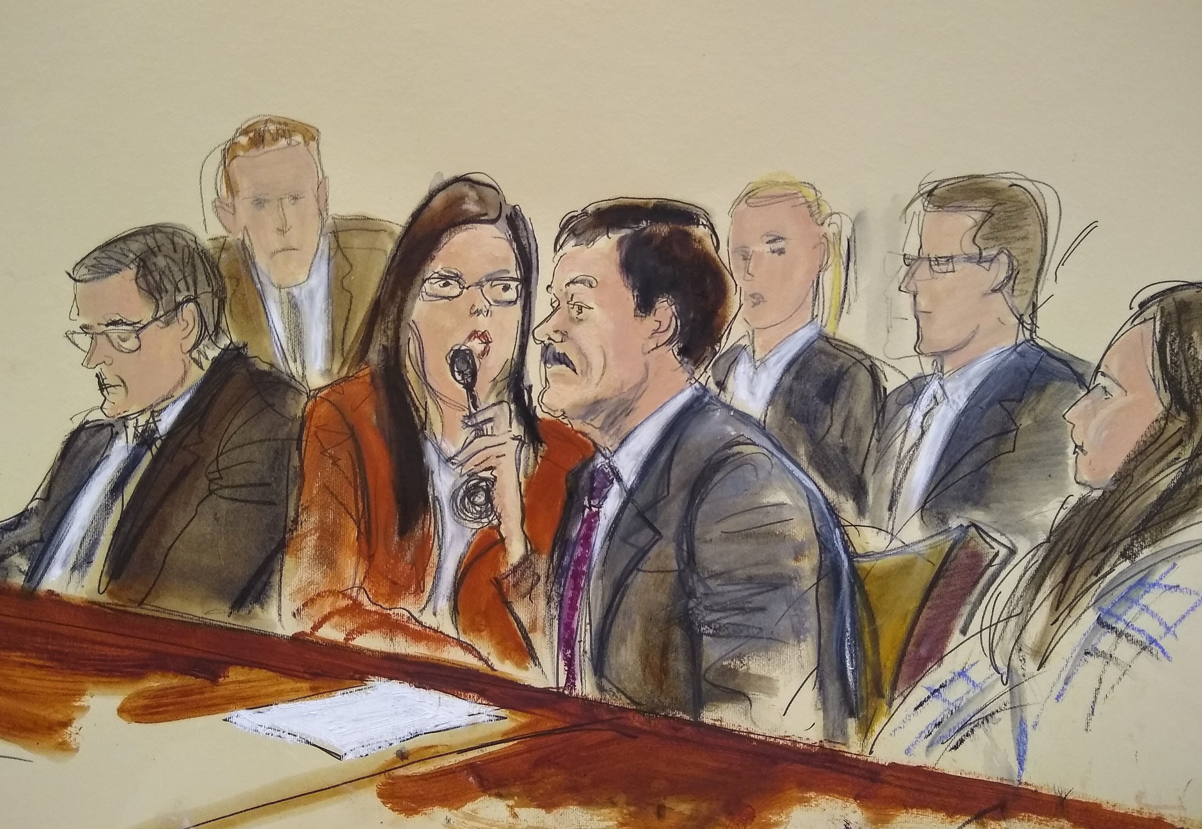 In this courtroom sketch, Joaquin "El Chapo" Guzman, second from right, listens to his sentence via interpreter while surrounded by U.S. Marshals and flanked by his defense attorney Marc Fernich, during his sentencing in federal court, Wednesday, July 17, 2019, in New York. The Mexican drug kingpin, who was convicted in February 2019 on multiple conspiracy counts in an epic drug-trafficking case, was sentenced to life behind bars in a U.S. prison Wednesday. (Elizabeth Williams via AP)