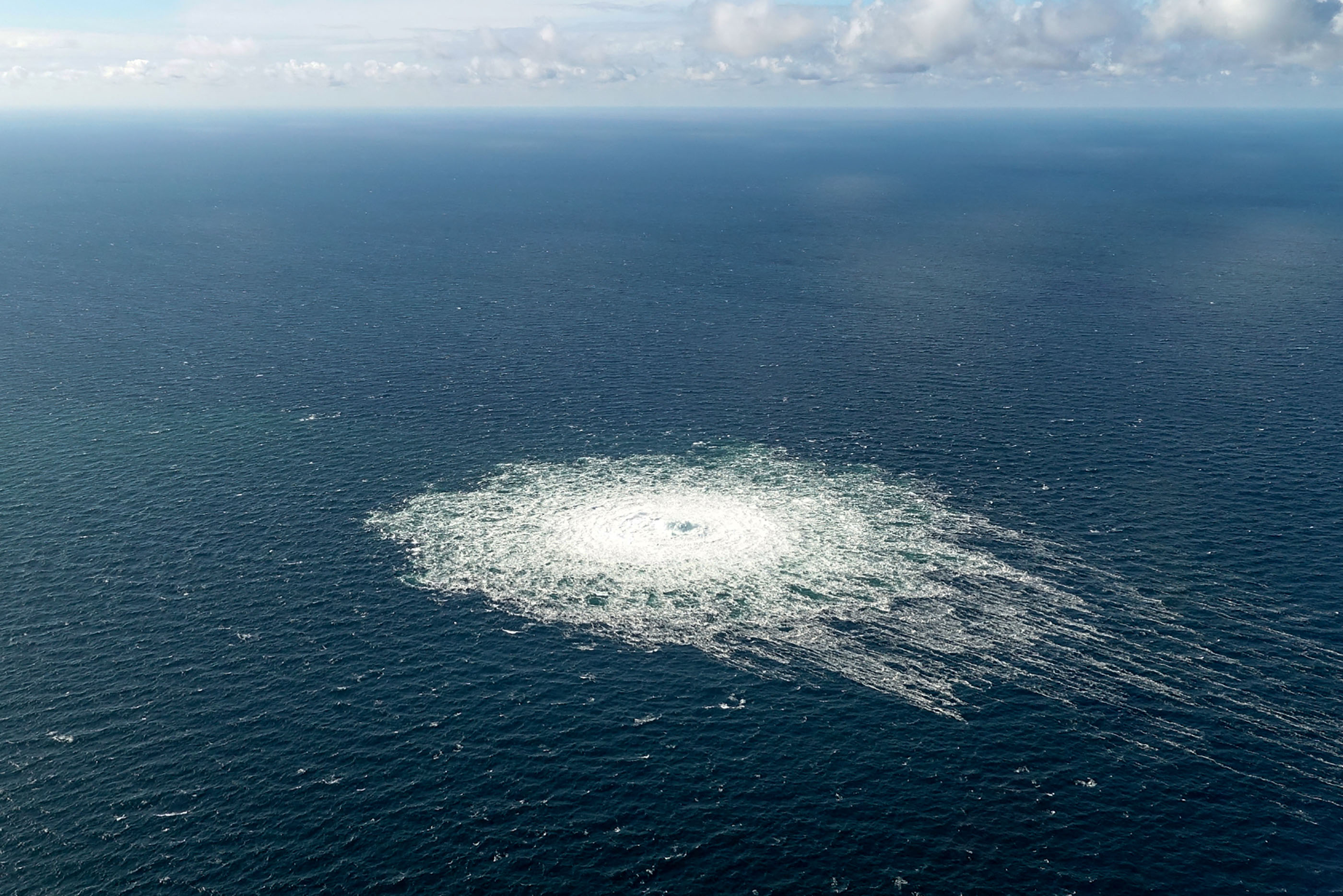 TOPSHOT - This handout picture released on September 27, 2022 by the Danish Defence Command shows the gas leak at the Nord Stream 2 gas pipeline as it is seen from the Danish Defence's F-16 rejection response off the Danish Baltic island of Bornholm, south of Dueodde. - The two Nord Stream gas pipelines linking Russia and Europe have been hit by unexplained leaks, Scandinavian authorities said on September 27, 2022, raising suspicions of sabotage. The pipelines have been at the centre of geopolitical tensions in recent months as Russia cut gas supplies to Europe in suspected retaliation against Western sanctions following its invasion of Ukraine. (Photo by Handout / DANISH DEFENCE / AFP) / RESTRICTED TO EDITORIAL USE - MANDATORY CREDIT "AFP PHOTO / DANISH DEFENCE " - NO MARKETING - NO ADVERTISING CAMPAIGNS - DISTRIBUTED AS A SERVICE TO CLIENTS - LARGER VERSION