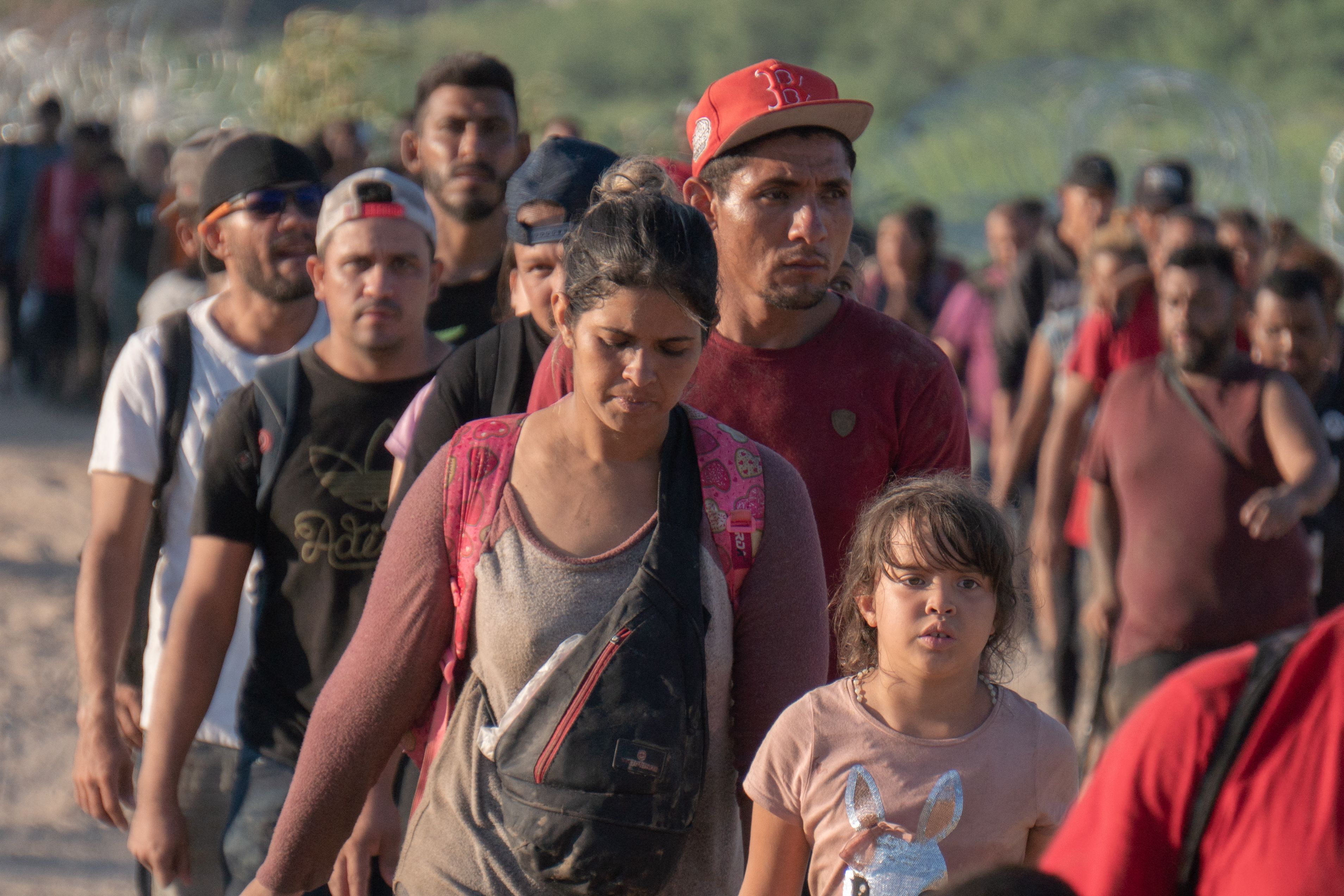 Migrants arrive in the US after crossing the Rio Grande from Mexico at Eagle Pass, Texas, on September 23, 2023. Dozens of migrants arrived at the US-Mexico border September 22, hoping to be allowed into the United States, with US border forces reporting 1.8 million encounters with migrants in the last 12 months. (Photo by Jesus Olarte / AFP)
