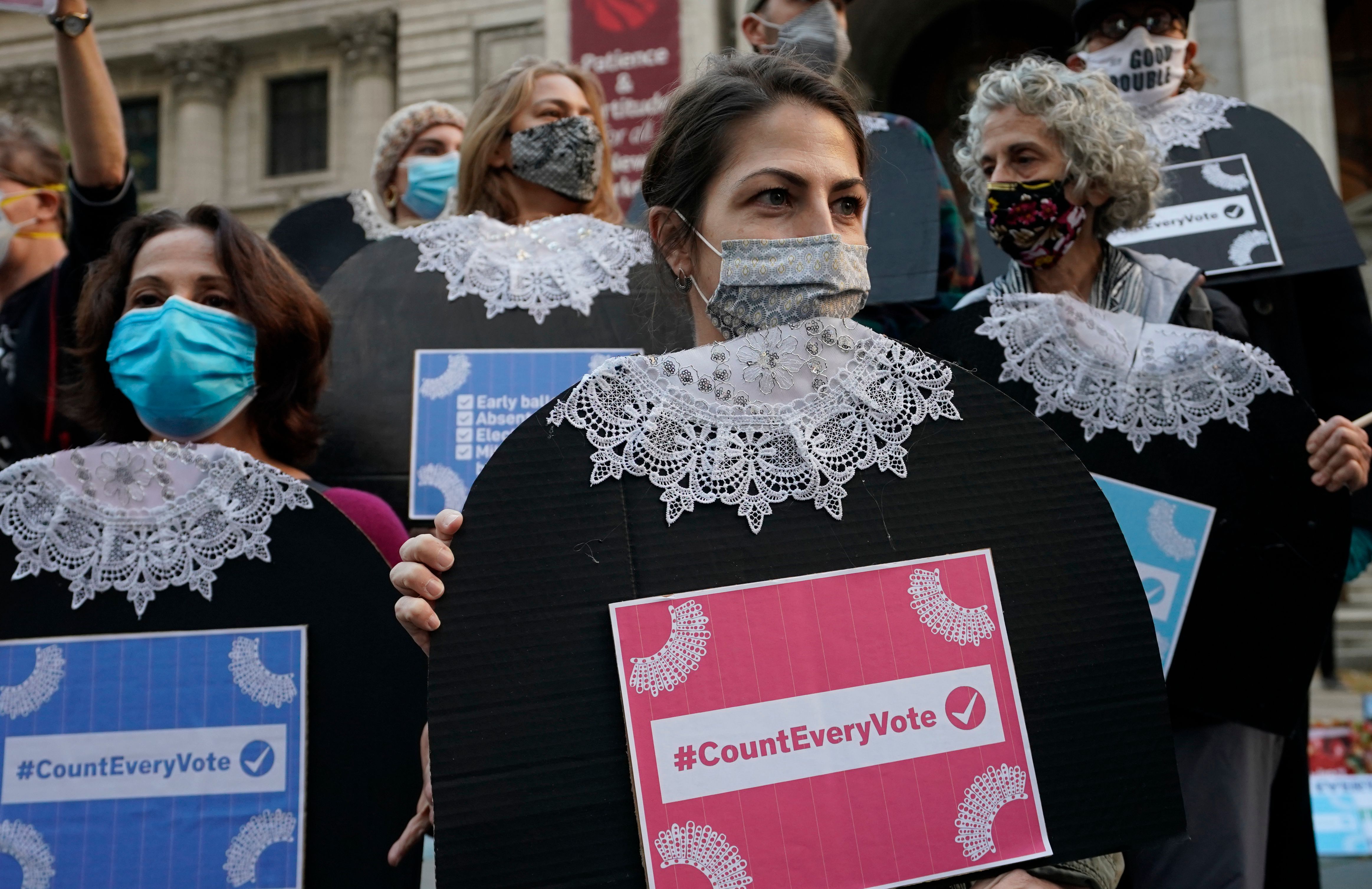 People gather at Fifth Avenue during a "Count Every Vote" rally in New York on November 4, 2020. - Democratic presidential challenger Joe Biden on November 4 neared the magic number of 270 electoral votes needed to win the White House with several battleground states still in play, as incumbent President Donald Trump challenged the vote count. (Photo by TIMOTHY A. CLARY / AFP)