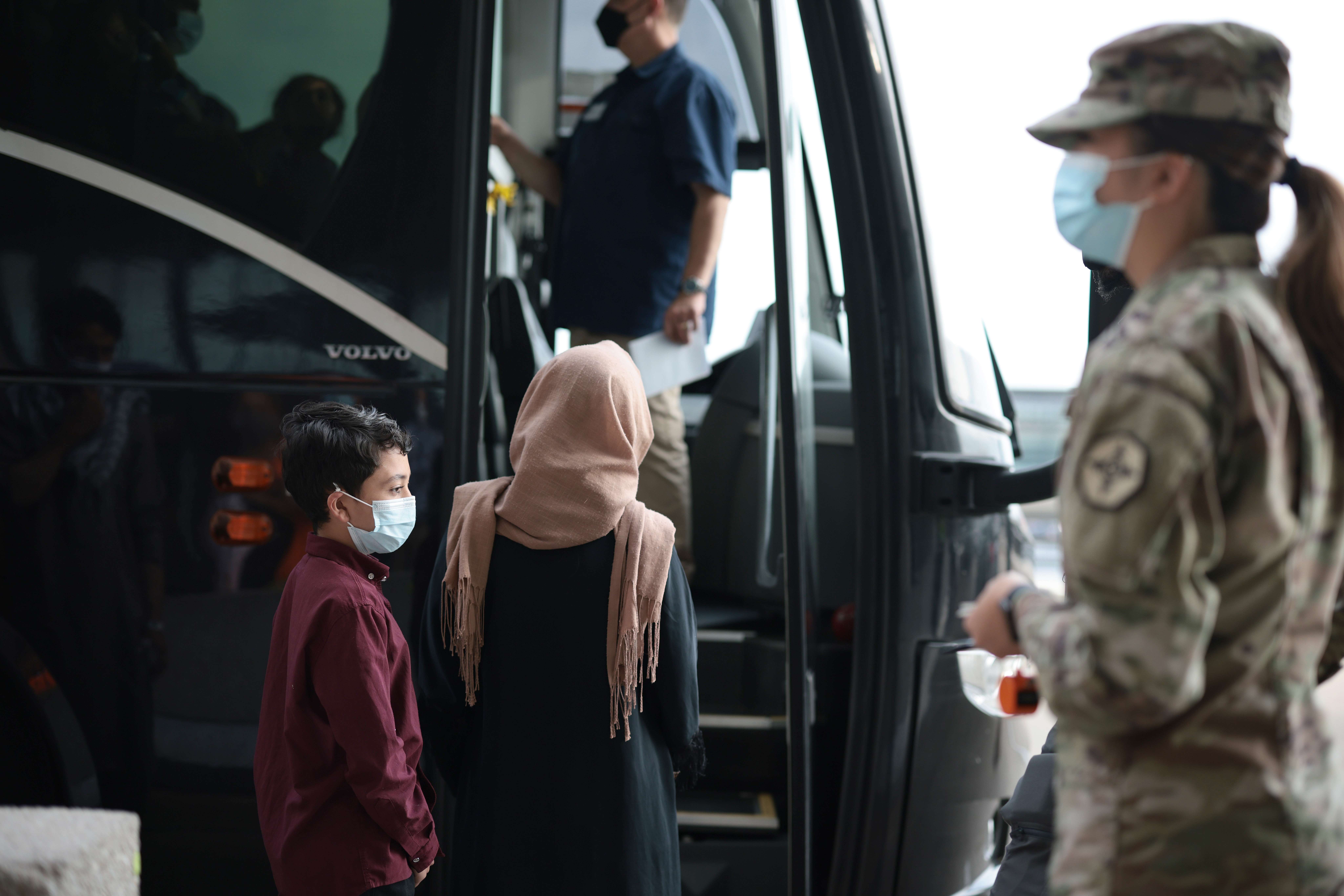 DULLES, VIRGINIA - AUGUST 31: Refugees board a bus at Dulles International Airport that will take them to a refugee processing center after being evacuated from Kabul following the Taliban takeover of Afghanistan on August 31, 2021 in Dulles, Virginia. The Department of Defense announced yesterday that the U.S. military had completed its withdrawal from Afghanistan, ending 20 years of war. Anna Moneymaker/Getty Images/AFP
== FOR NEWSPAPERS, INTERNET, TELCOS & TELEVISION USE ONLY ==