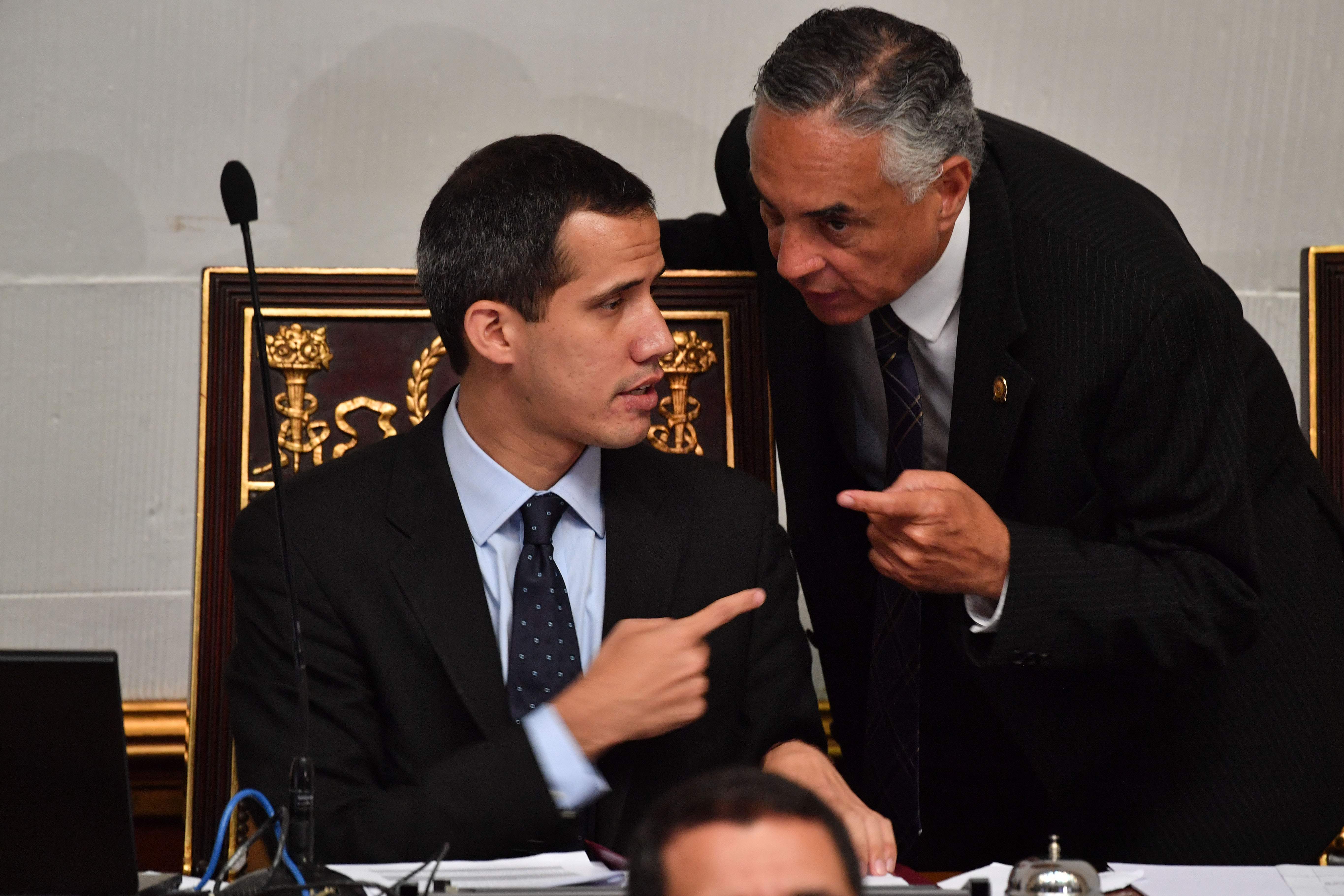 El jefe de la Asamblea Nacional de Venezuela y presidente interino, Juan Guaido, habla con el diputado Rafael Veloz, durante una sesión en la Asamblea Nacional, en Caracas, el 29 de enero de 2019. Foto: AFP