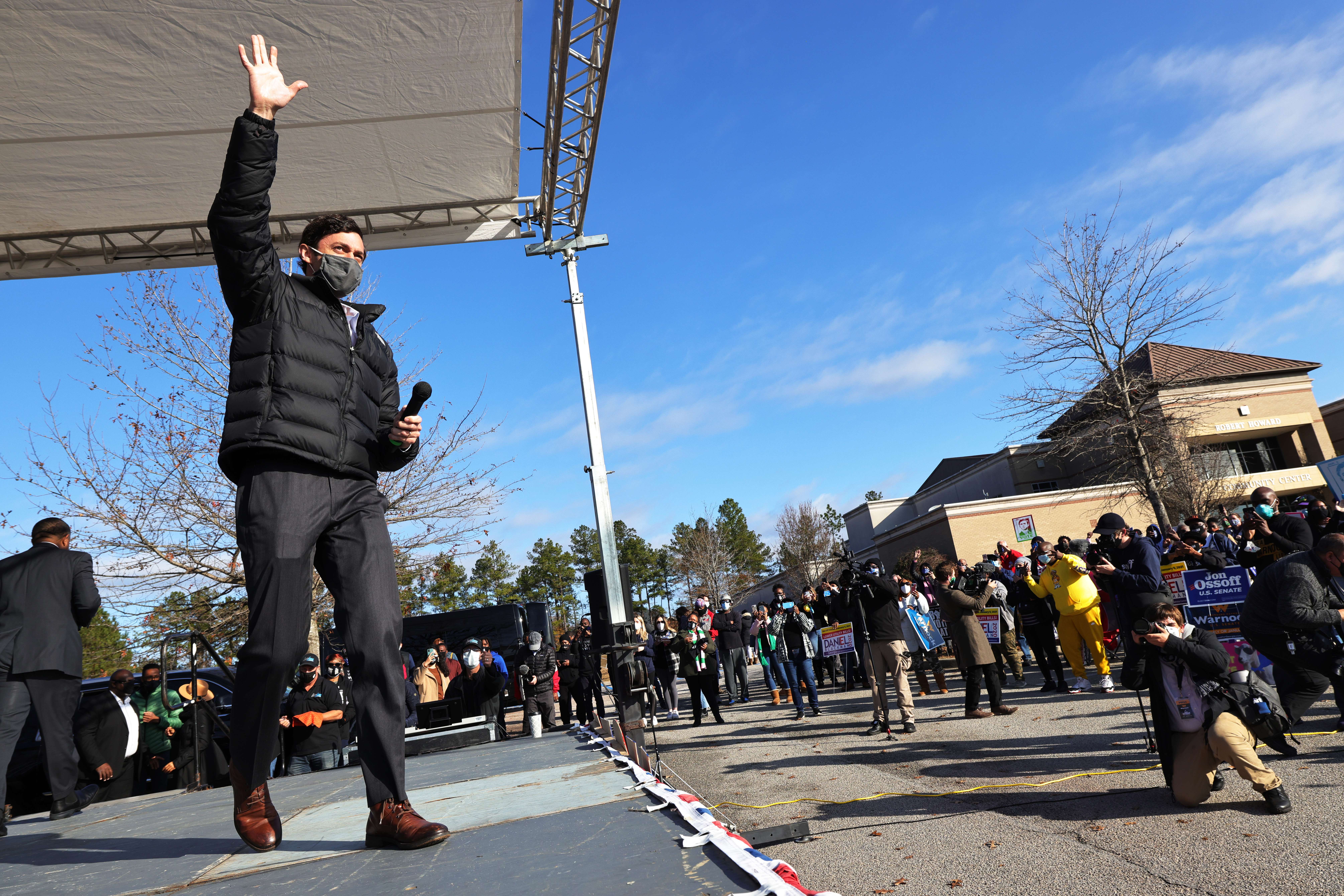 HEPHZIBAH, GEORGIA - JANUARY 04: Georgia Democratic Senate candidate Jon Ossoff greets people as he takes the stage at an Augusta canvass launch block party at Robert Howard Community Center on January 04, 2021 in Hephzibah, Georgia. On the final day before the January 5th runoff election, Warnock and Ossoff, who are challenging Republican incumbent senators Kelly Loeffler and David Perdue, respectively, made their last pitches to voters at a block party and canvass launch. Michael M. Santiago/Getty Images/AFP
== FOR NEWSPAPERS, INTERNET, TELCOS & TELEVISION USE ONLY ==