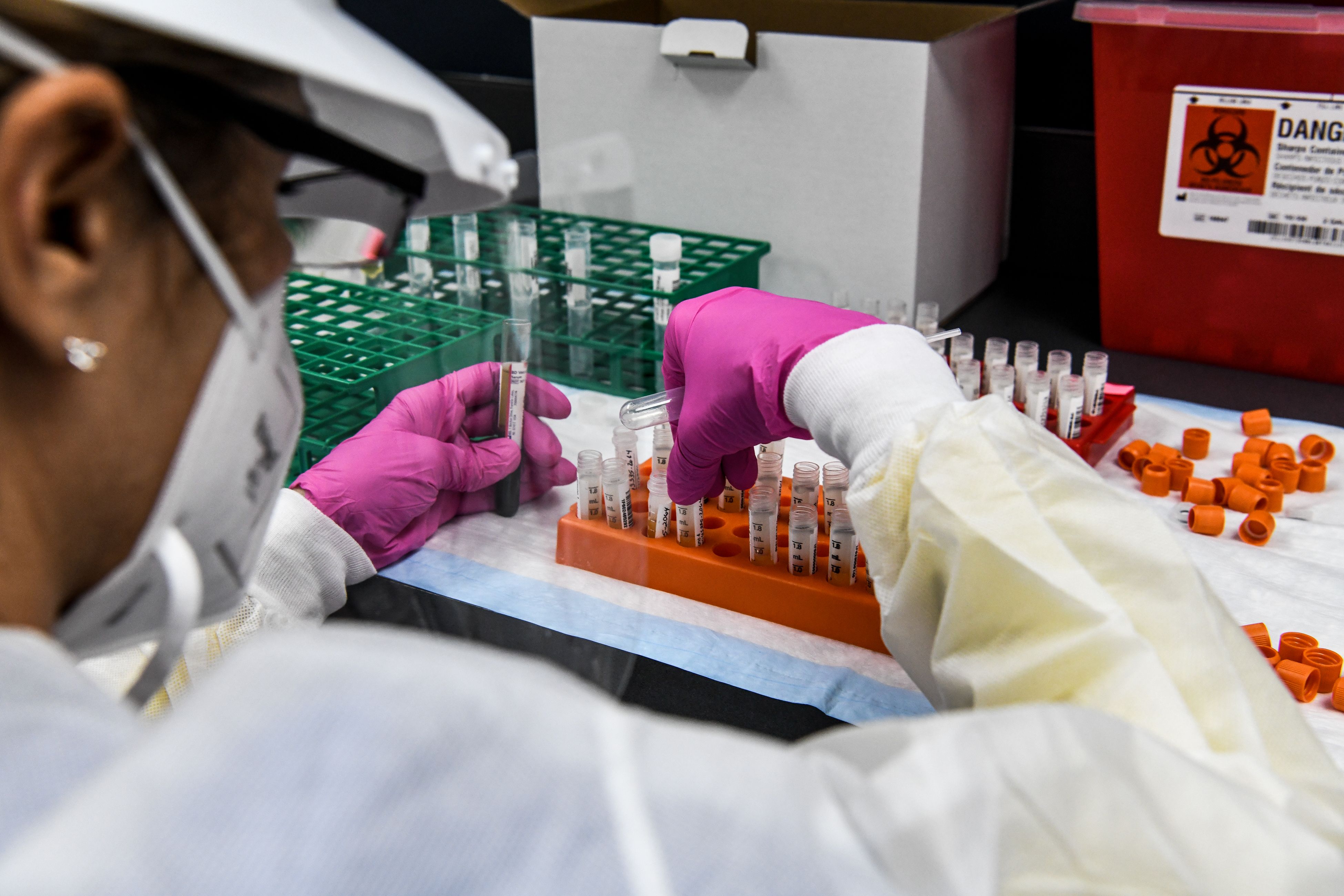 (FILES) In this file photo taken on August 13, 2020, a lab technician sorts blood samples inside a lab for a Covid-19 vaccine study at the Research Centers of America (RCA) in Hollywood, Florida. - A key facet of the global mad scramble by Pfizer, Moderna and other pharma groups to develop a viable coronavirus vaccine is the recruitment of tens of thousands of volunteers willing to participate in clinical trials. AFP's correspondent in Miami, Leila Macor, took part in such a trial organized by US biotech firm Moderna, which on November 16, 2020 announced that its experimental vaccine against Covid-19 was nearly 95 percent effective.
Why did Macor, who suffers from asthma, decide to be one of Moderna's 30,000 test subjects? Here, she recounts her experience, which began just weeks after her own father died of Covid-19 in Chile. (Photo by CHANDAN KHANNA / AFP)