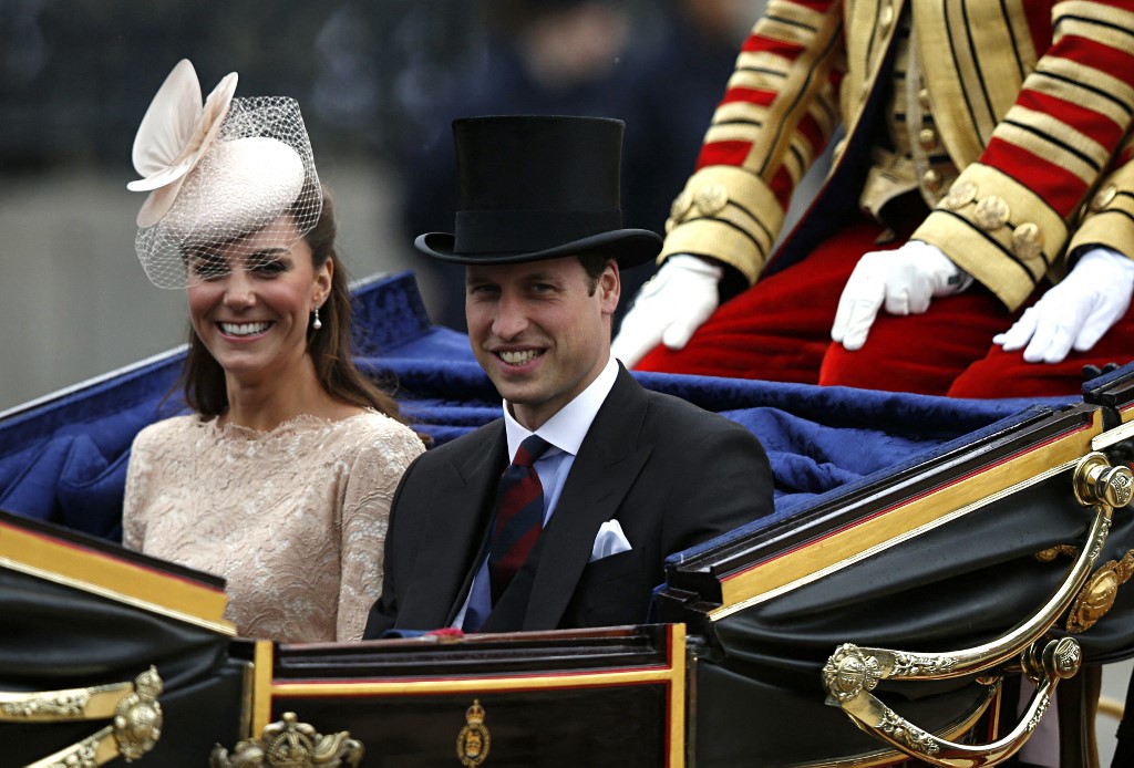 (FILES) In this file photo taken on June 5, 2012 Prince William and Catherine Duchess of Cambridge leave Westminster Hall on a carriage after a Diamond Jubilee Luncheon in London. - William and Kate have brought a more relaxed and personal approach to royal duties and are raising their children in relatively hands-on fashion, presenting a more modern vision of the monarchy for a new age. The well-liked couple, formally known as the Duke and Duchess of Cambridge, married in 2011 and have presented themselves and their three children -- George, Charlotte and Louis -- as a model family. (Photo by Kevin Coombs / POOL / AFP)