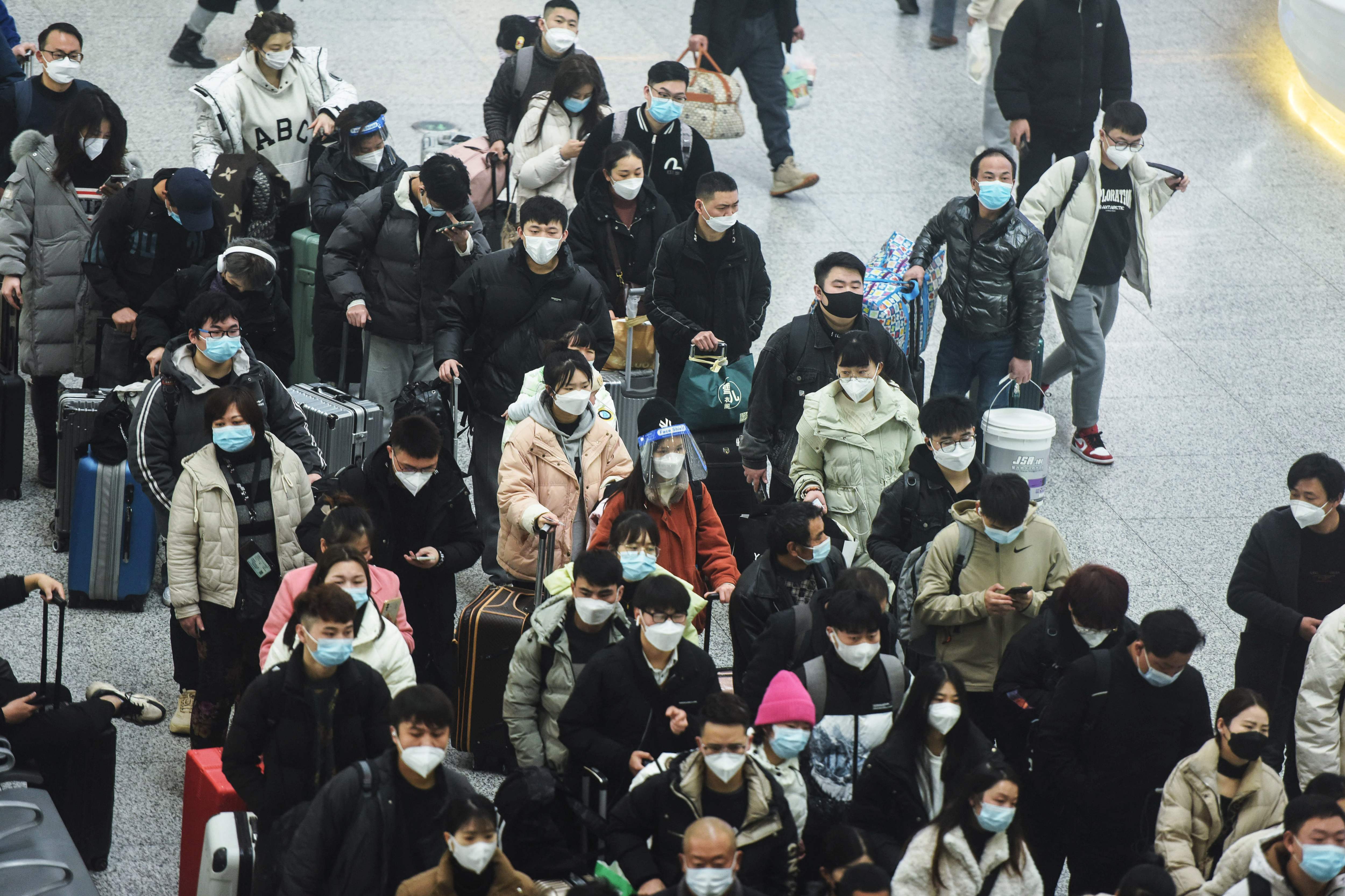 This photo taken on January 7, 2023 shows passengers arriving at Hangzhou East railway station on the first day of peak travel ahead of the Lunar New Year of the Rabbit, in China's eastern Zhejiang province. (Photo by AFP) / China OUT