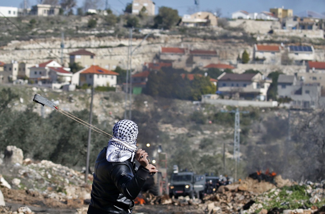 Un palestino se enfrentó con una honda a fuerzas israelíes durante una protesta, el viernes, contra la exporación de un terreno en la aldea de Kfar Qaddum, cerca de Naplusa, Cisjordania.