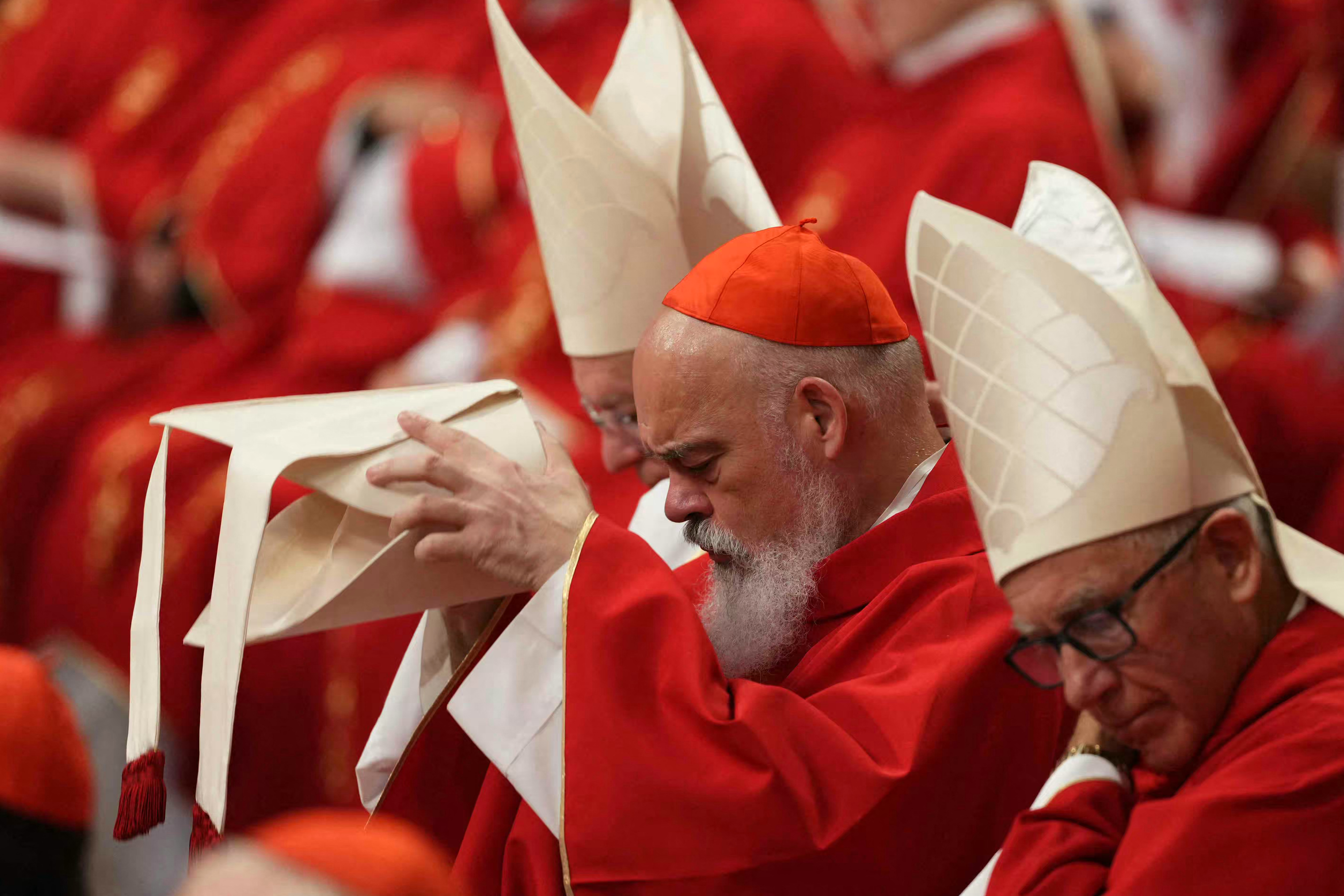 (FILES) This handout picture released by the Press office shows cardinals queuing in the Sistine Chapel to swear on the Bible to never reveal the secrets of their deliberations before the start of the conclave at the Vatican on March 12, 2013. Catholic cardinals meeting in Rome on April 28, 2025, agreed to begin on May 7, 2025, the conclave to elect a successor to Pope Francis, according to ANSA news agency. On Wednesday May 7, the cardinals will take part in a solemn mass at St Peter's Basilica in the Vatican, after which those eligible to vote will gather in the Sistine Chapel for the secretive ballot, which can last several days. (Photo by Handout / OSSERVATORE ROMANO / AFP) / RESTRICTED TO EDITORIAL USE - MANDATORY CREDIT "AFP PHOTO / OSSERVATORE ROMANO" - HANDOUT - NO MARKETING NO ADVERTISING CAMPAIGNS - DISTRIBUTED AS A SERVICE TO CLIENTS