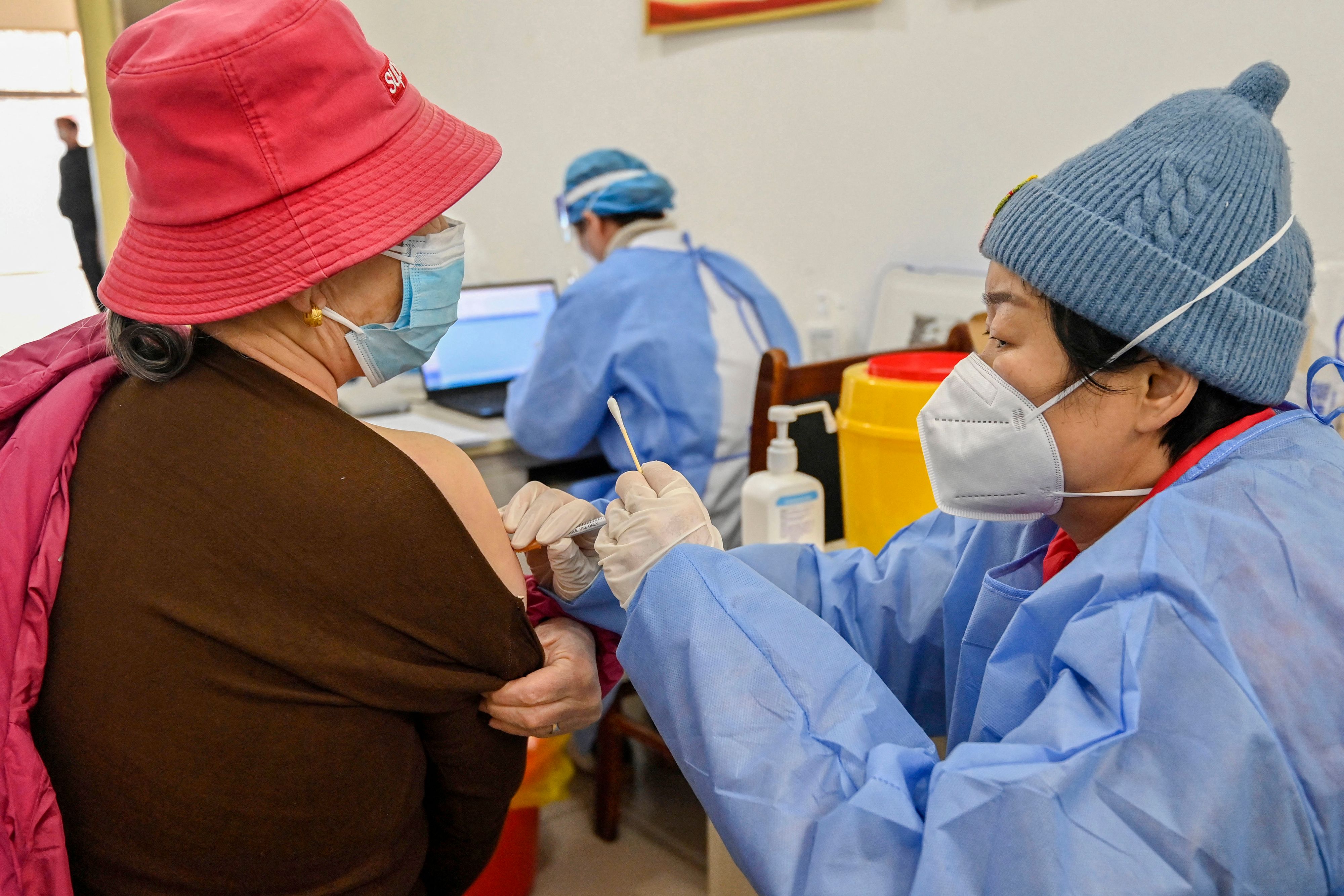 A woman receives a Covid-19 coronavirus vaccine in Qingzhou, in China's eastern Shandong province on December 29, 2022. (Photo by AFP) / China OUT