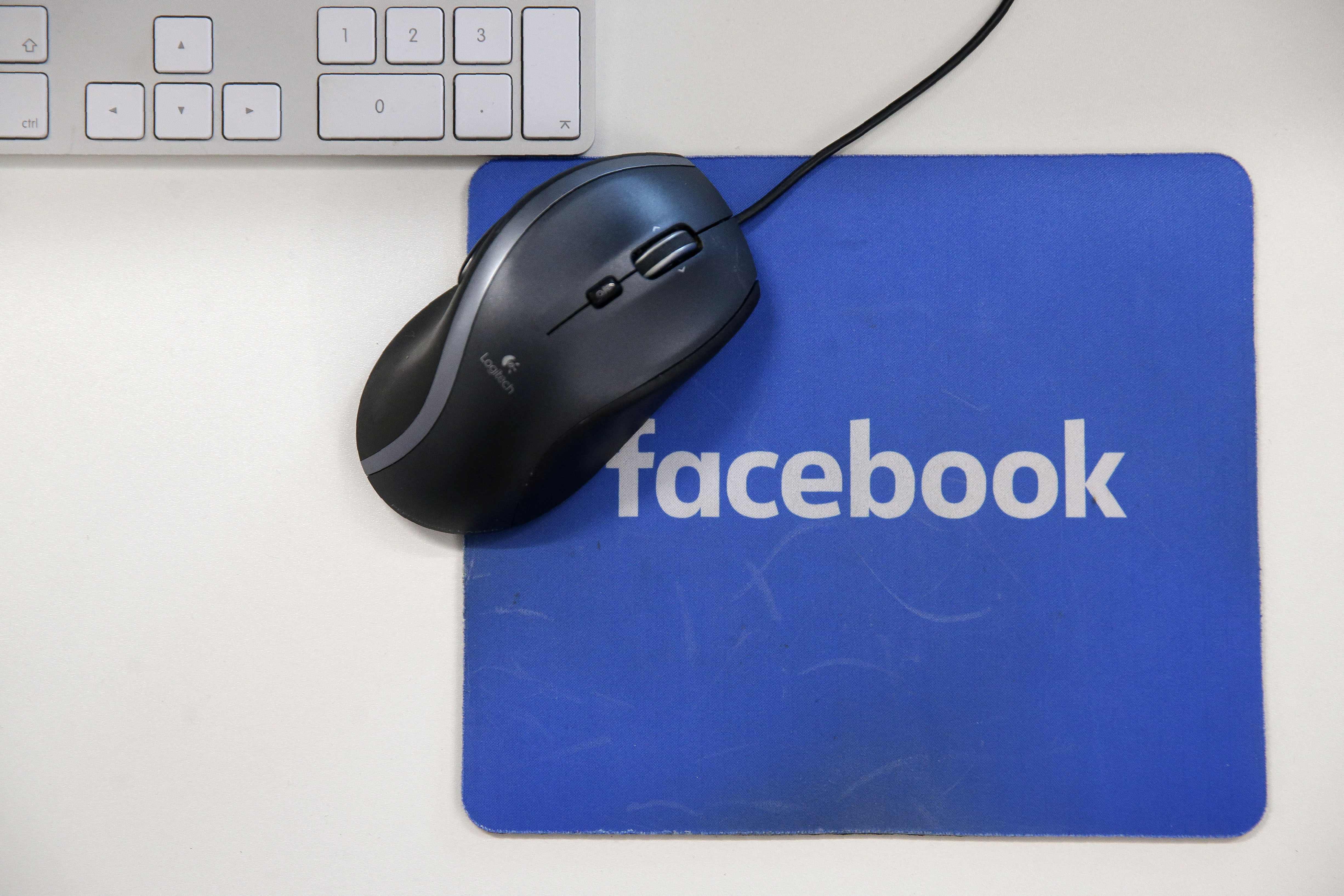 (FILES) This file photo illustration taken on December 4, 2017 shows mousepad with the Facebook logo at Facebook's new headquarters at Rathbone Place in central London. - Facebook was branded "arrogant" and "unconscionable" for banning Australian users from sharing news on February 18, 2021, as its defiant response to government regulation inadvertently crippled the pages of several emergency services. (Photo by Daniel LEAL-OLIVAS / AFP)