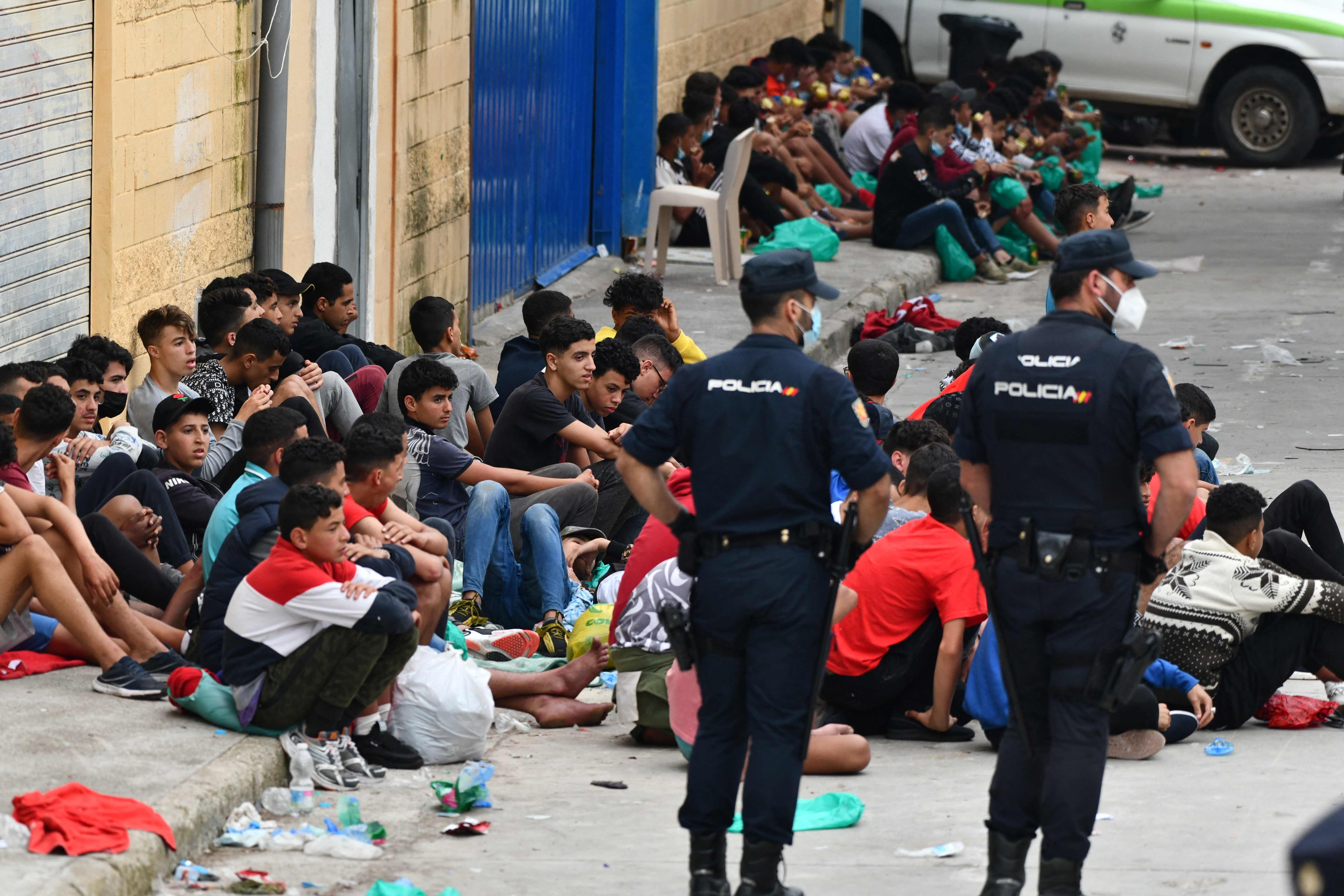 Migrant minors wait to be tested for COVID-19 upon their arrival to the Spanish enclave of Ceuta, on May 19, 2021. - Migrants were still trying to cross from Morocco into the Spanish enclave of Ceuta after a record 8,000 people poured over the border this week, escalating tensions between Rabat and Madrid. (Photo by Antonio Sempere / AFP) / Restricted to editorial use - To illustrate the event as specified in the caption