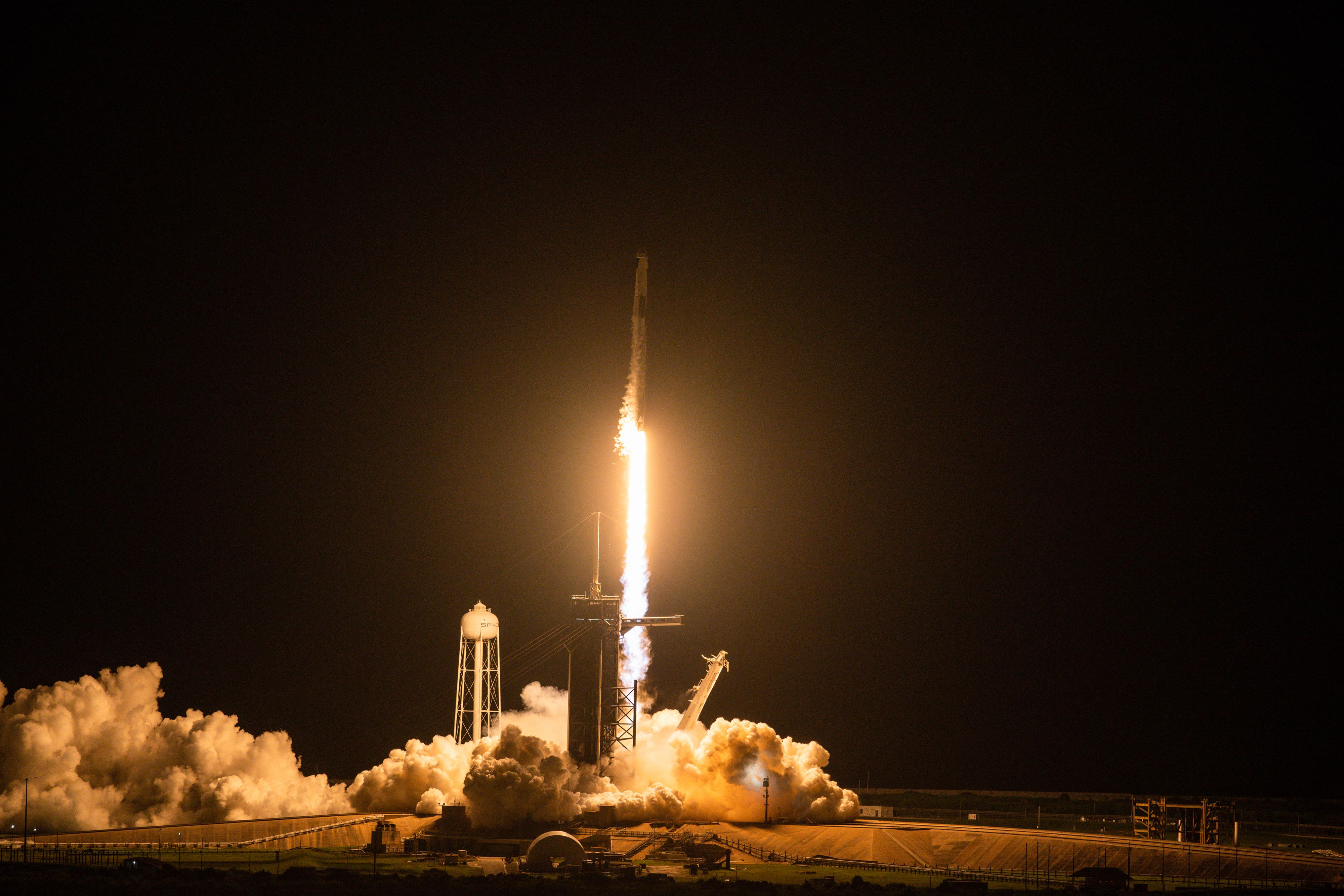 The SpaceX Falcon 9 rocket carrying the Inspiration4 crew launches from Pad 39A at NASA's Kennedy Space Center in Cape Canaveral, Florida on September 15, 2021. - The Inspiration4 mission, the first to send an all-civilian crew to orbit, will venture deeper into space than the International Space Station. (Photo by CHANDAN KHANNA / AFP)