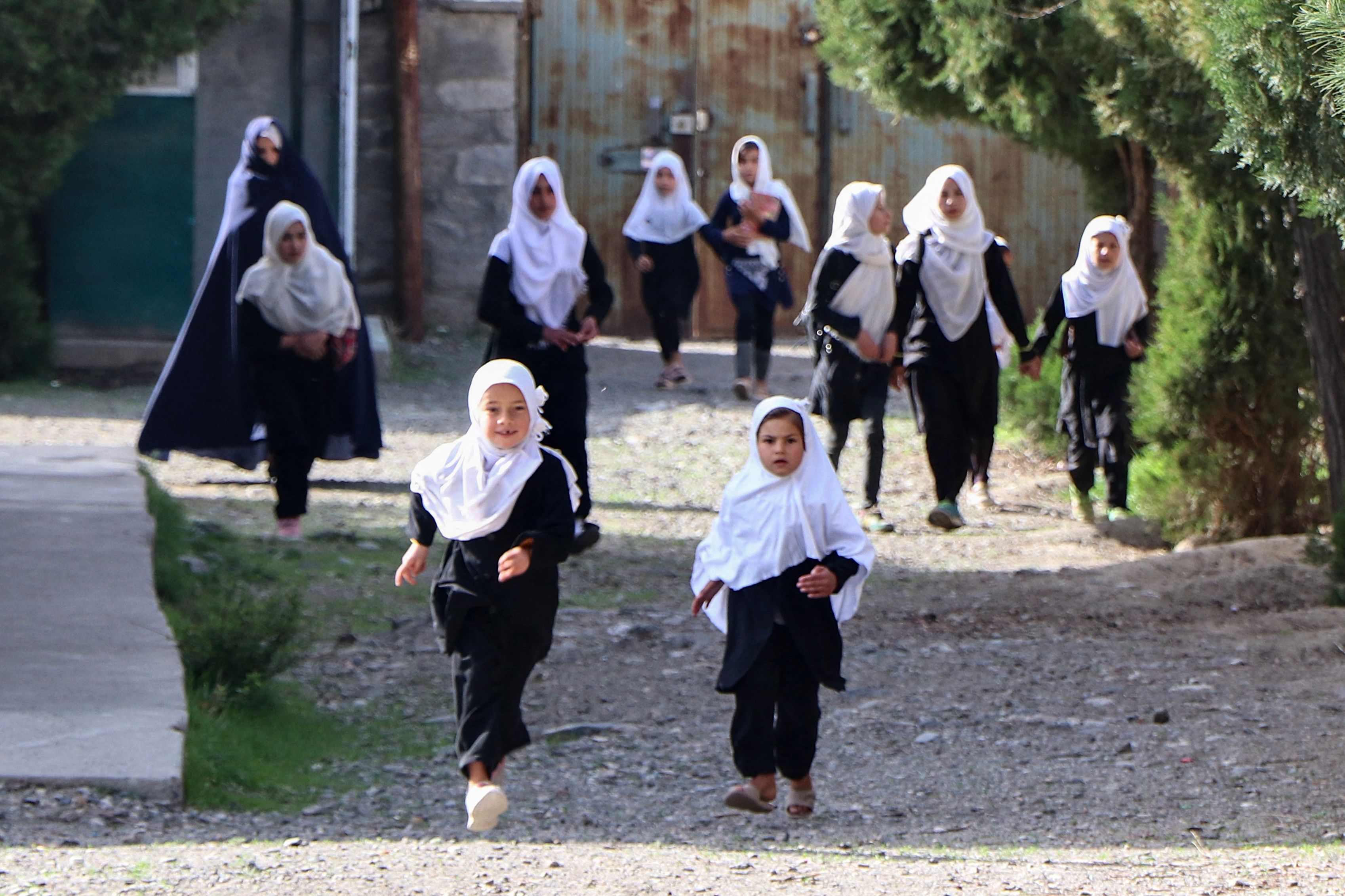 Girls arrive at their school in Panjshir on March 23, 2022. - The Taliban ordered girls' secondary schools in Afghanistan to shut on March 23 just hours after they reopened, an official confirmed, sparking confusion and heartbreak over the policy reversal by the hardline Islamist group. (Photo by AFP)