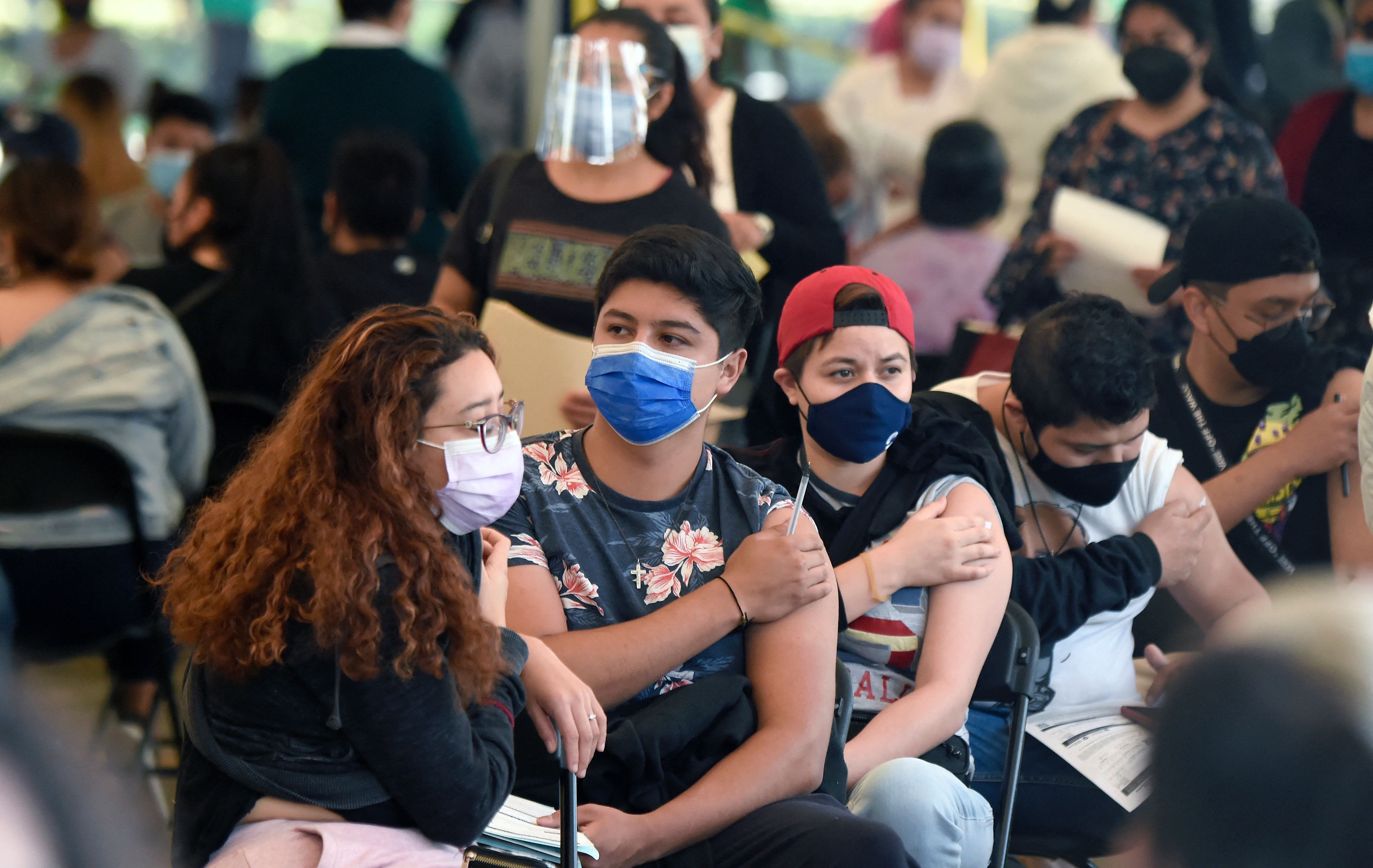 People wait after receiving their first dose of the Sputnik-V vaccine against COVID-19 in Mexico City, on July 27, 2021. - Population between 18 and 29 years are receiving their first dose against the virus, as Mexico faces a third wave of COVID-19 contagions. Although the indicators of deaths and hospitalizations remain far from the January levels -when the occupancy rate was of 95% and the dead toll more than 900 deaths per day- infections have accelerated and last week, for the first time in a month, the number of deaths exceeded 300 reported in 24 hours. (Photo by ALFREDO ESTRELLA / AFP)