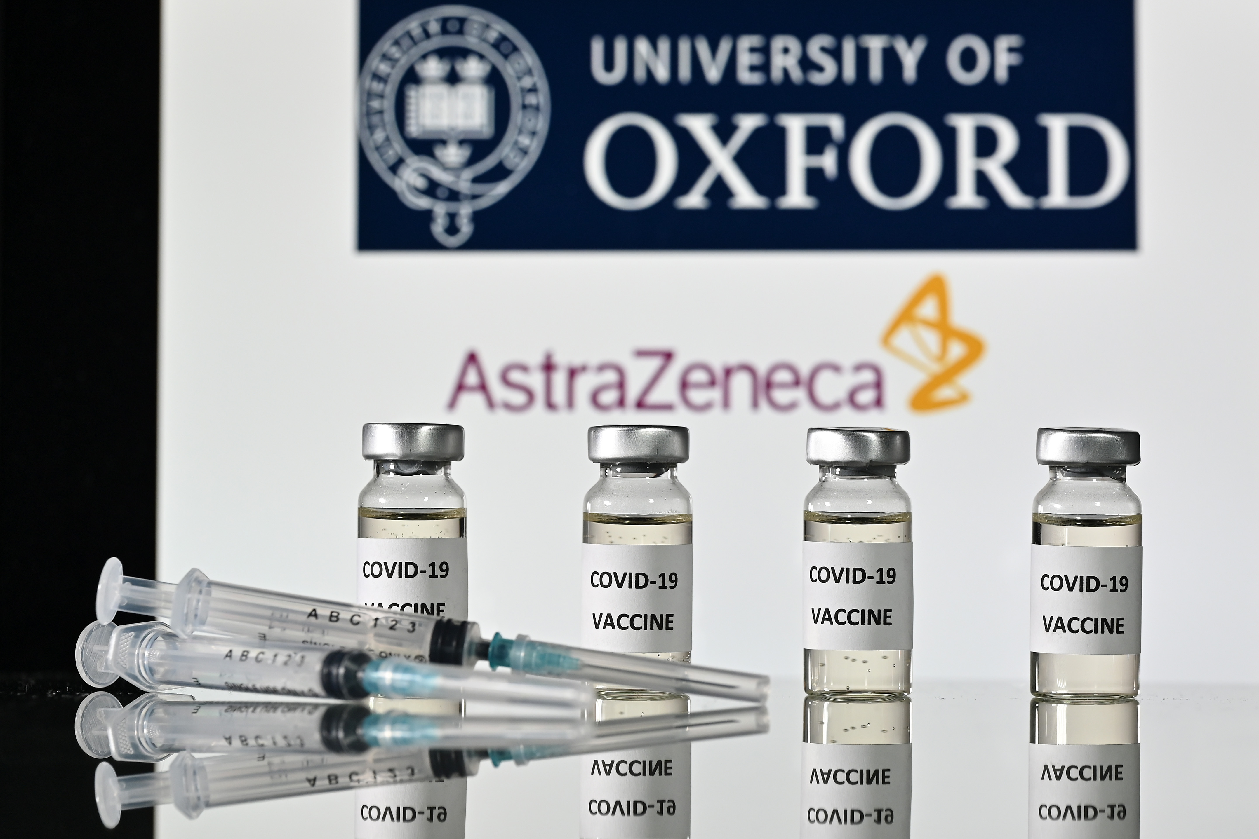 (FILES) In this file photo taken on November 17, 2020 An illustration picture shows vials with Covid-19 Vaccine stickers attached and syringes, with the logo of the University of Oxford and its partner British pharmaceutical company AstraZeneca. - British drugs group AstraZeneca and the University of Oxford on November 23, 2020 said their jointly-developed vaccine against Covid-19 has shown "an average efficacy of 70 percent" in trials. The results ranged between 62 and 90 percent efficacy depending on the vaccine dosage. (Photo by JUSTIN TALLIS / AFP)