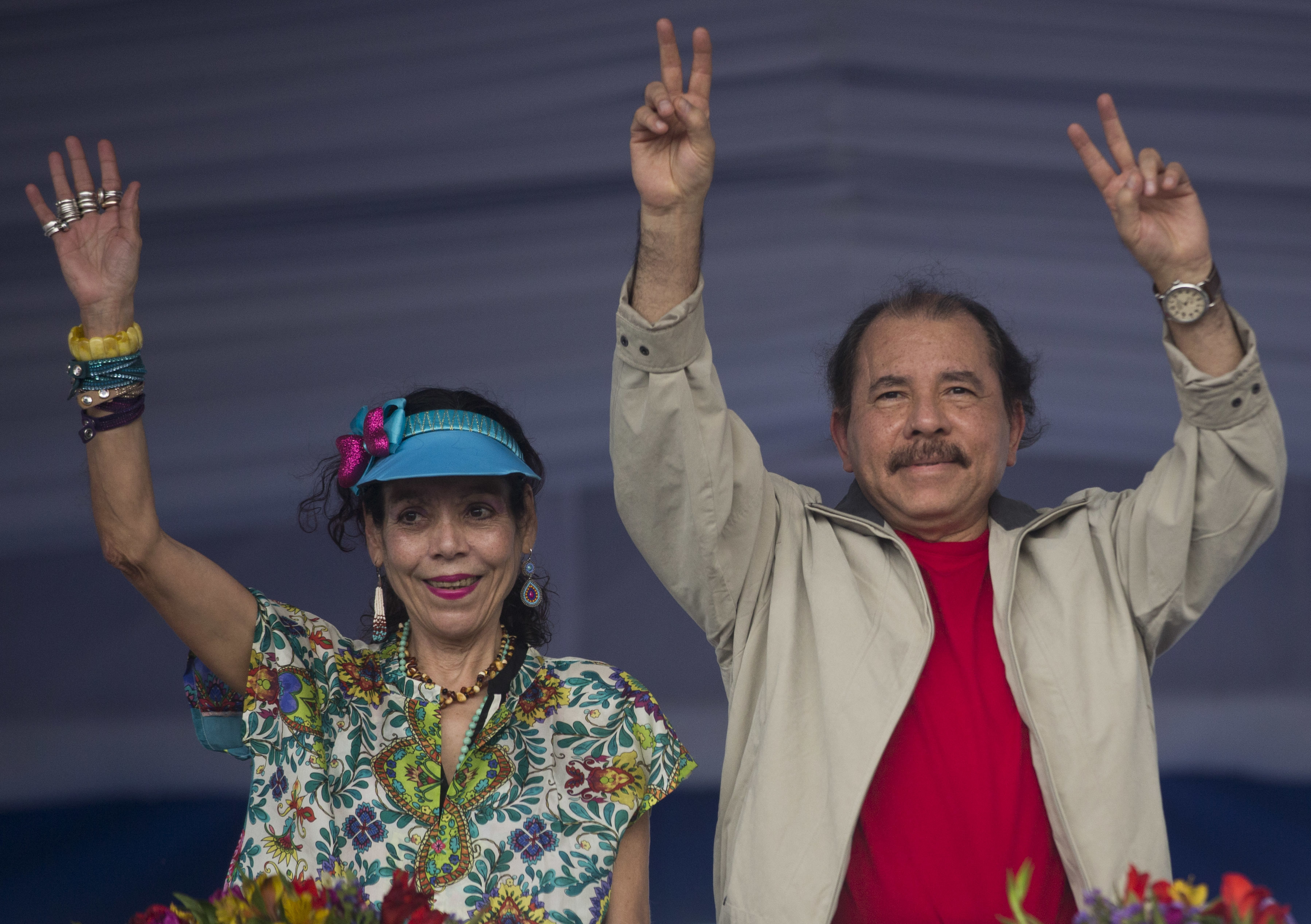 FILE - In this July 3, 2015, file photo, Nicaragua's President Daniel Ortega, right, and first lady Rosario Murillo, wave to supporters during an event commemorating the 36th anniversary of the Sandinista National Liberation Front withdrawal to Masaya, in Managua, Nicaragua. Nicaragua’s governing Sandinista party has named the first lady on Tuesday, Aug. 2, 2016, as the running-mate of President Ortega in his bid for a third term in Nov. 6 election. (AP Photo/Esteban Felix,File)