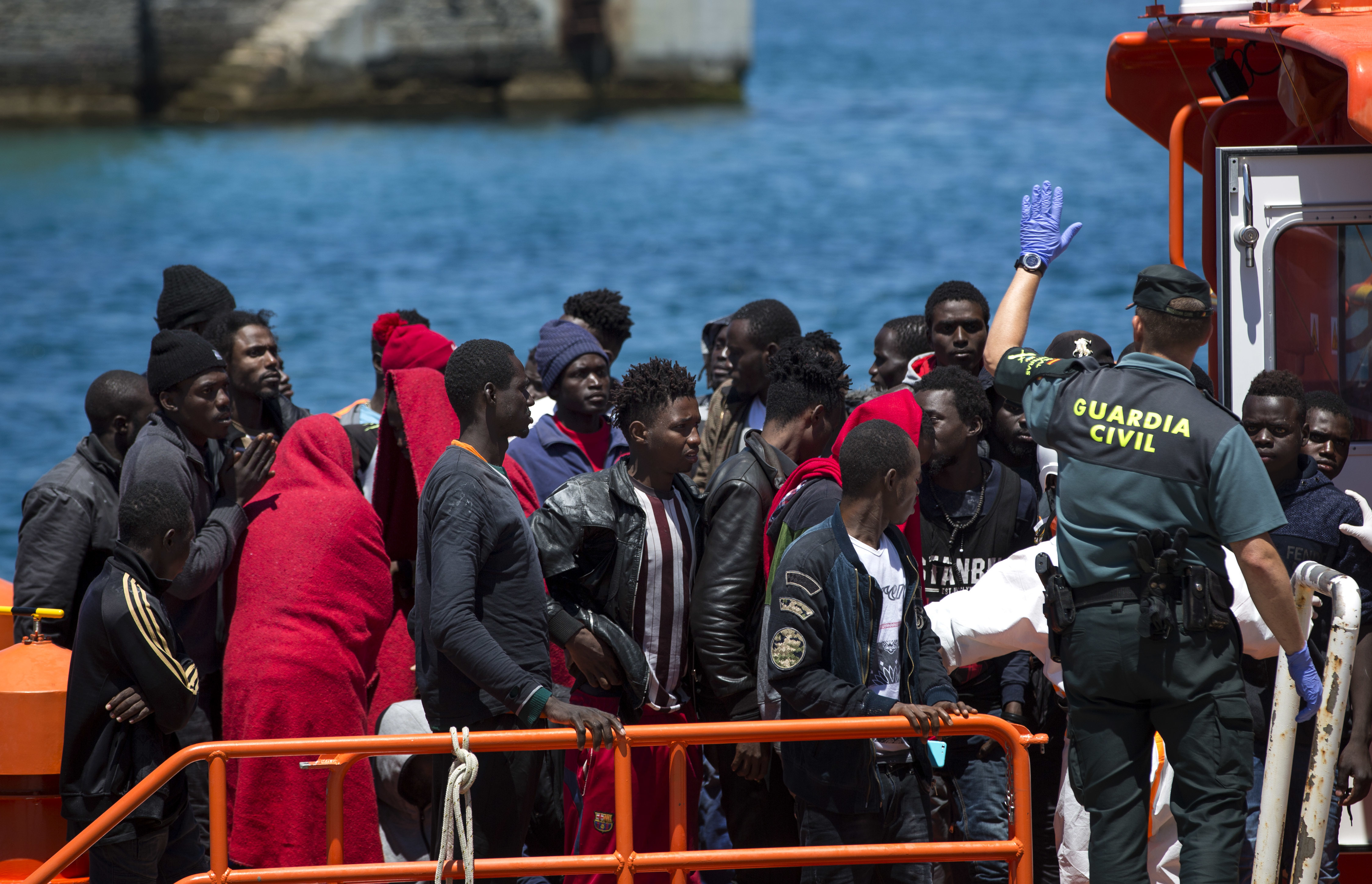 Migrants arrive at the port of Tarifa, southern Spain, after being rescued by Spain's Maritime Rescue Service in the Strait of Gibraltar, Friday, June. 29, 2018. European Union leaders declared victory Friday, claiming to have set aside major differences over how best to handle migrant arrivals as they commissioned new plans to screen people in North Africa for eligibility to enter Europe. (AP Photo/Emilio Morenatti)