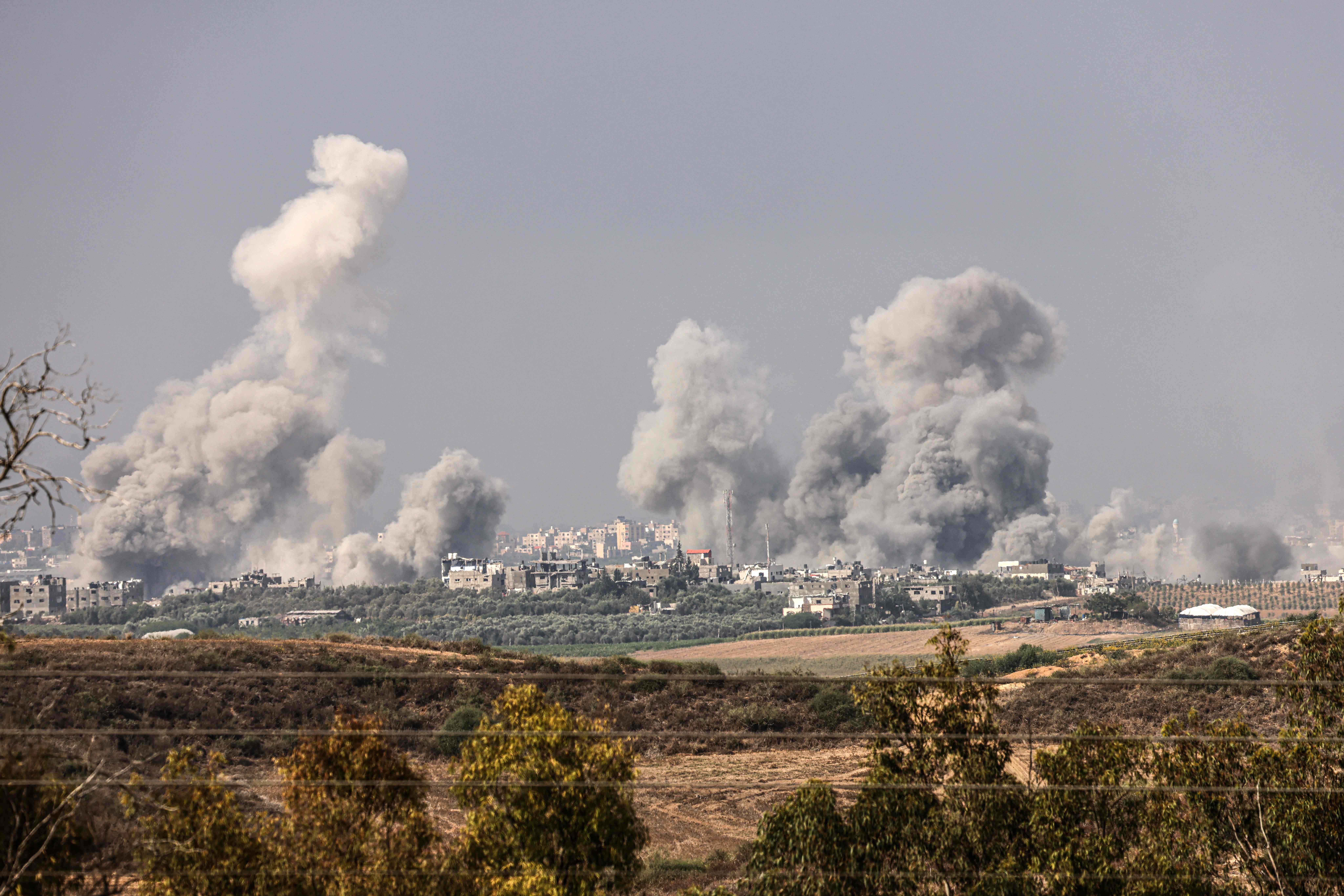 EDITORS NOTE: Graphic content / TOPSHOT - A picture taken from the southern Israeli city of Sderot on October 23, 2023, shows smoke and debris ascending over the northern Gaza Strip following an Israeli strike, amid the ongoing battles between Israel and the Palestinian group Hamas. Thousands of people, both Israeli and Palestinians have died since October 7, 2023, after Palestinian Hamas militants based in the Gaza Strip, entered southern Israel in a surprise attack leading Israel to declare war on Hamas in Gaza on October 8. (Photo by Jack Guez / AFP)