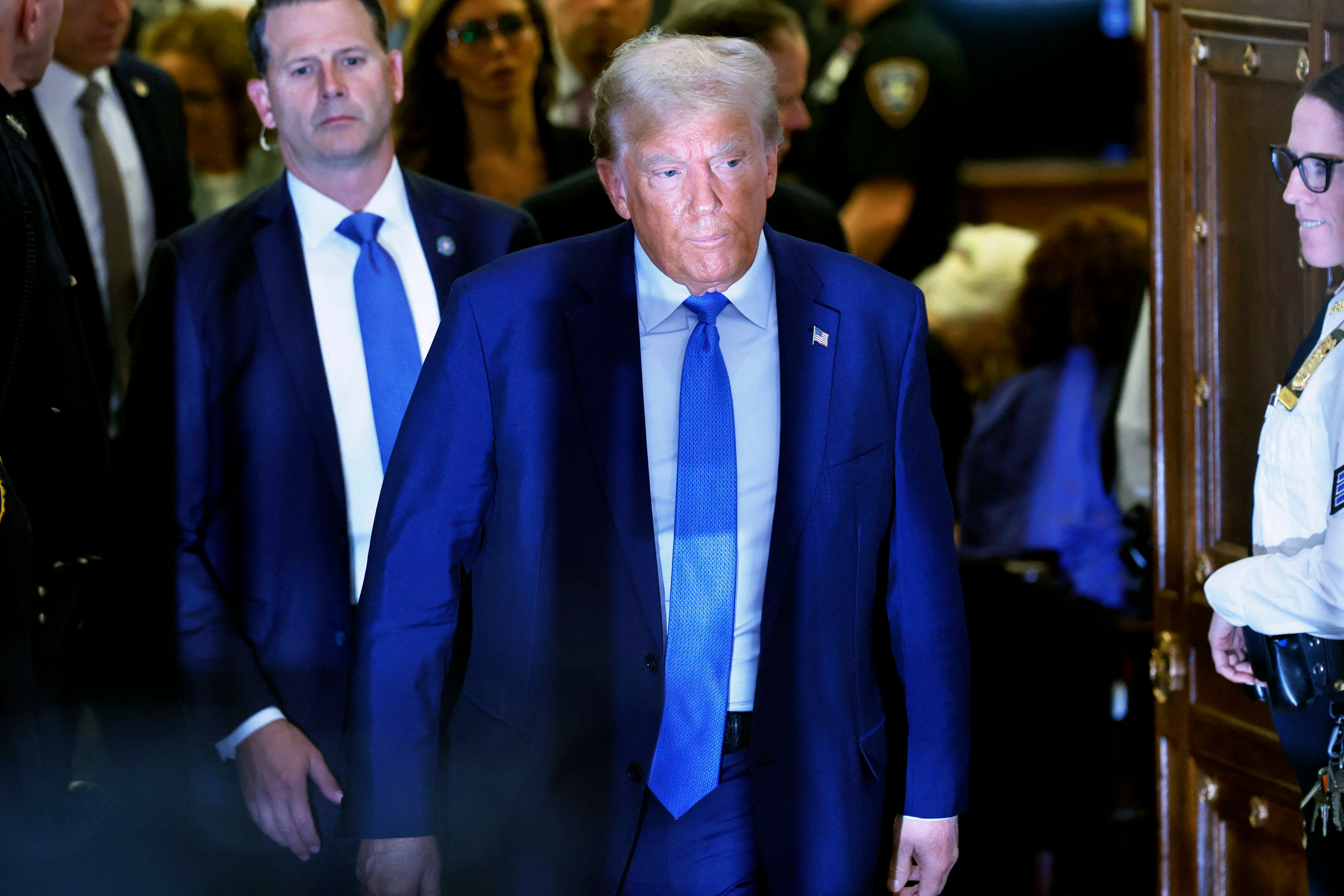 NEW YORK, NEW YORK - NOVEMBER 06: Former President Donald Trump leaves the courtroom for a lunch break during his civil fraud trial at New York State Supreme Court on November 06, 2023 in New York City. Trump is scheduled to testify in the civil fraud trial that alleges that he and his two sons Donald Trump Jr. and Eric Trump conspired to inflate his net worth on financial statements provided to banks and insurers to secure loans. New York Attorney General Letitia James has sued seeking $250 million in damages. His sons testified in the trial last week and his daughter Ivanka Trump is scheduled to testify on Wednesday after her lawyers were unable to block her testimony. Michael M. Santiago/Getty Images/AFP (Photo by Michael M. Santiago / GETTY IMAGES NORTH AMERICA / Getty Images via AFP)