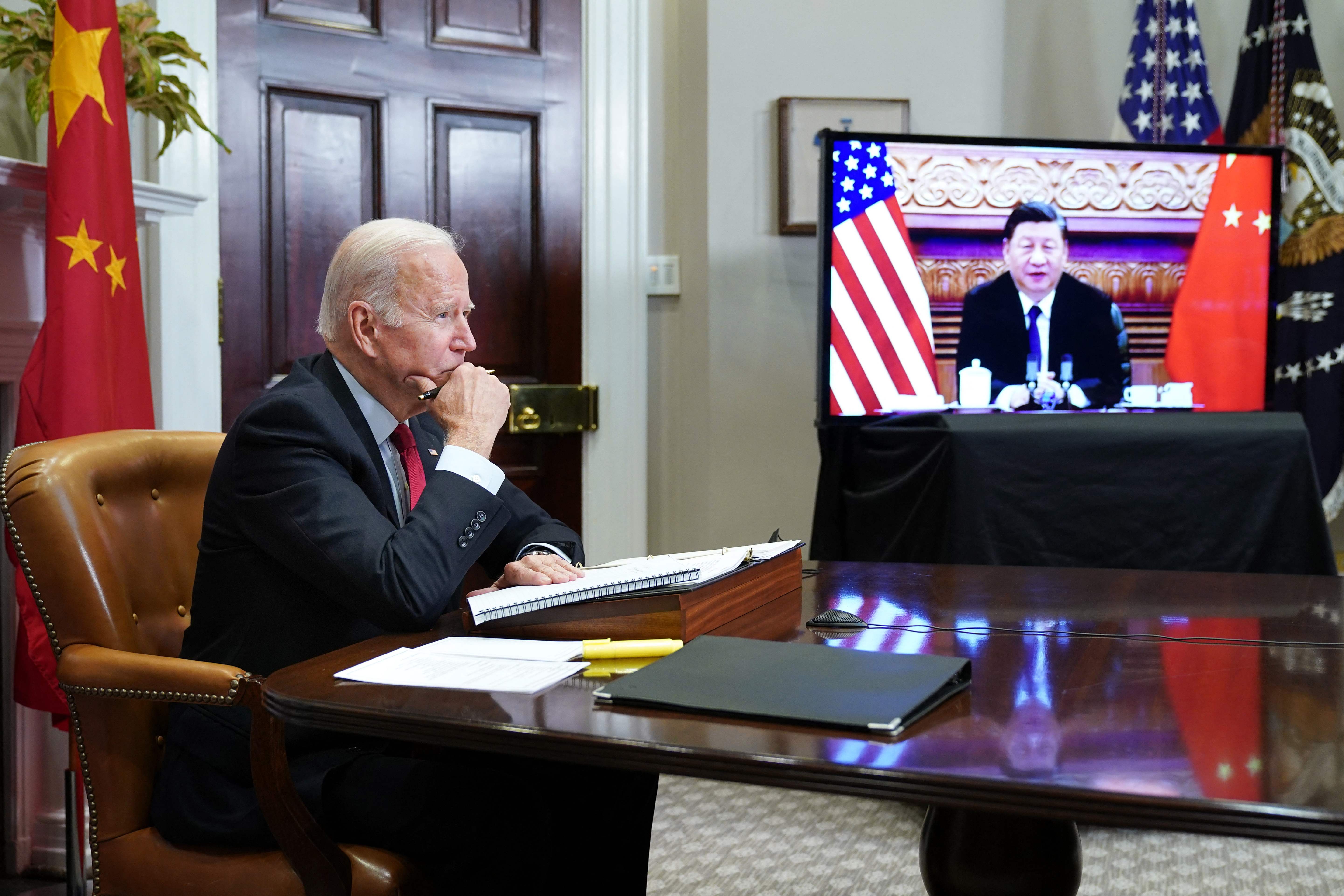 TOPSHOT - US President Joe Biden meets with China's President Xi Jinping during a virtual summit from the Roosevelt Room of the White House in Washington, DC, November 15, 2021. (Photo by MANDEL NGAN / AFP)