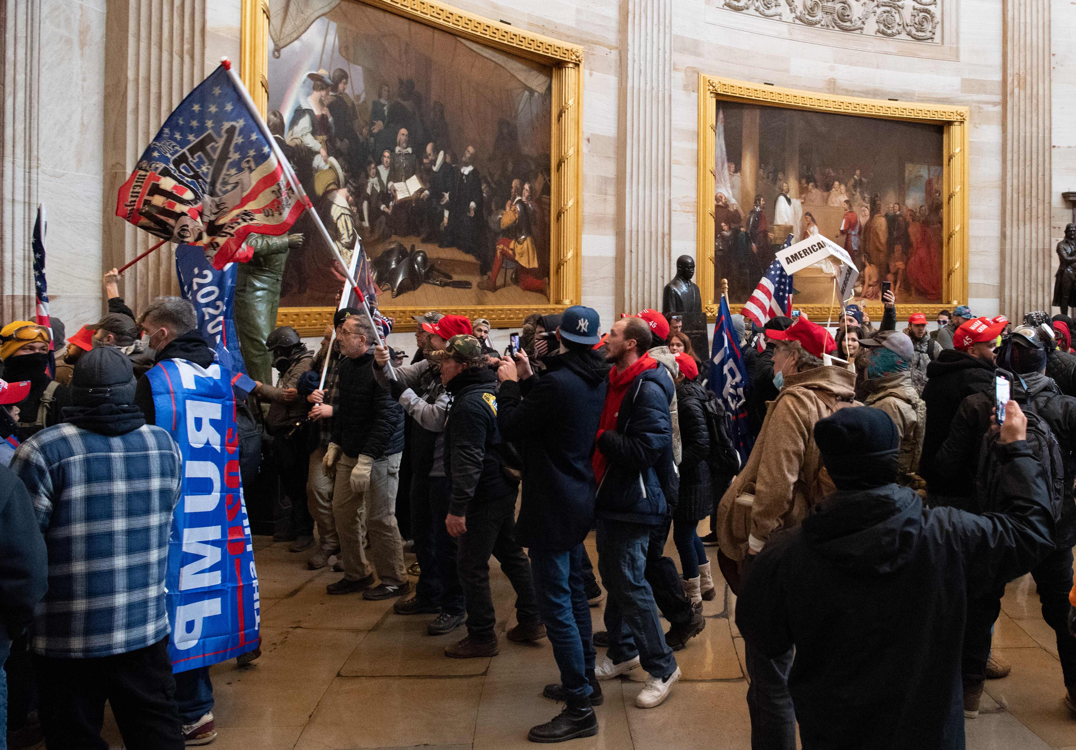 Supporters of US President Donald Trump protest in the US Capitol Rotunda on January 6, 2021, in Washington, DC. - Demonstrators breeched security and entered the Capitol as Congress debated the a 2020 presidential election Electoral Vote Certification. (Photo by SAUL LOEB / AFP)