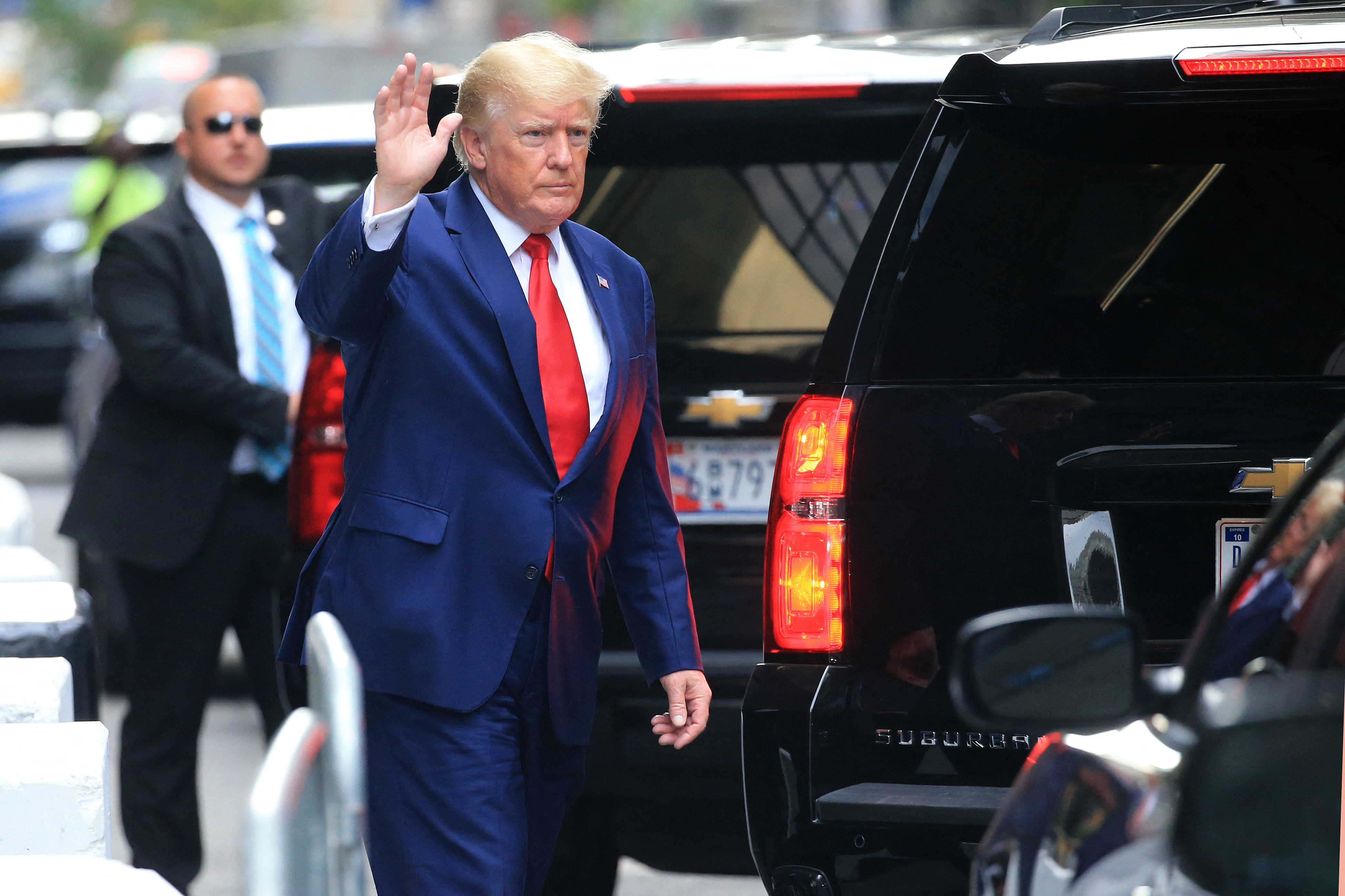 Former US President Donald Trump waves while walking to a vehicle outside of Trump Tower in New York City on August 10, 2022. - Donald Trump on Wednesday declined to answer questions under oath in New York over alleged fraud at his family business, as legal pressures pile up for the former president whose house was raided by the FBI just two days ago. (Photo by STRINGER / AFP)