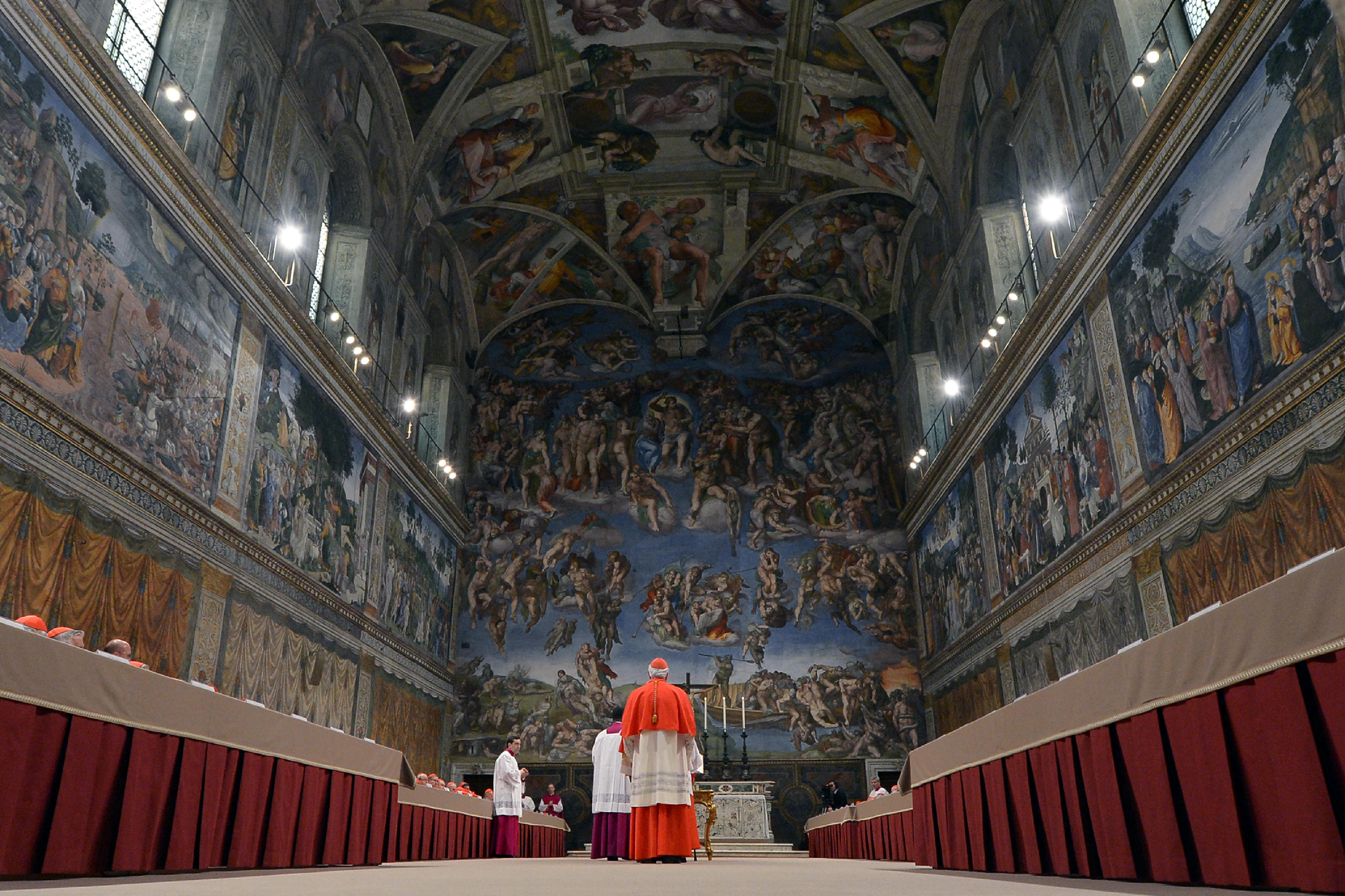 (FILES) This handout picture released by the Press office shows cardinals queuing in the Sistine Chapel to swear on the Bible to never reveal the secrets of their deliberations before the start of the conclave at the Vatican on March 12, 2013. Catholic cardinals meeting in Rome on April 28, 2025, agreed to begin on May 7, 2025, the conclave to elect a successor to Pope Francis, according to ANSA news agency. On Wednesday May 7, the cardinals will take part in a solemn mass at St Peter's Basilica in the Vatican, after which those eligible to vote will gather in the Sistine Chapel for the secretive ballot, which can last several days. (Photo by Handout / OSSERVATORE ROMANO / AFP) / RESTRICTED TO EDITORIAL USE - MANDATORY CREDIT "AFP PHOTO / OSSERVATORE ROMANO" - HANDOUT - NO MARKETING NO ADVERTISING CAMPAIGNS - DISTRIBUTED AS A SERVICE TO CLIENTS