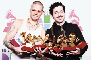 Rene Perez , left, also known as Residente, and Eduardo Jose Cabra Martinez, Visitante, of the musical group Calle 13, pose with their awards backstage at the 10th Annual Latin Grammy Awards on Thursday, Nov. 5, 2009, in Las Vegas. (AP Photo/Eric Jamison)