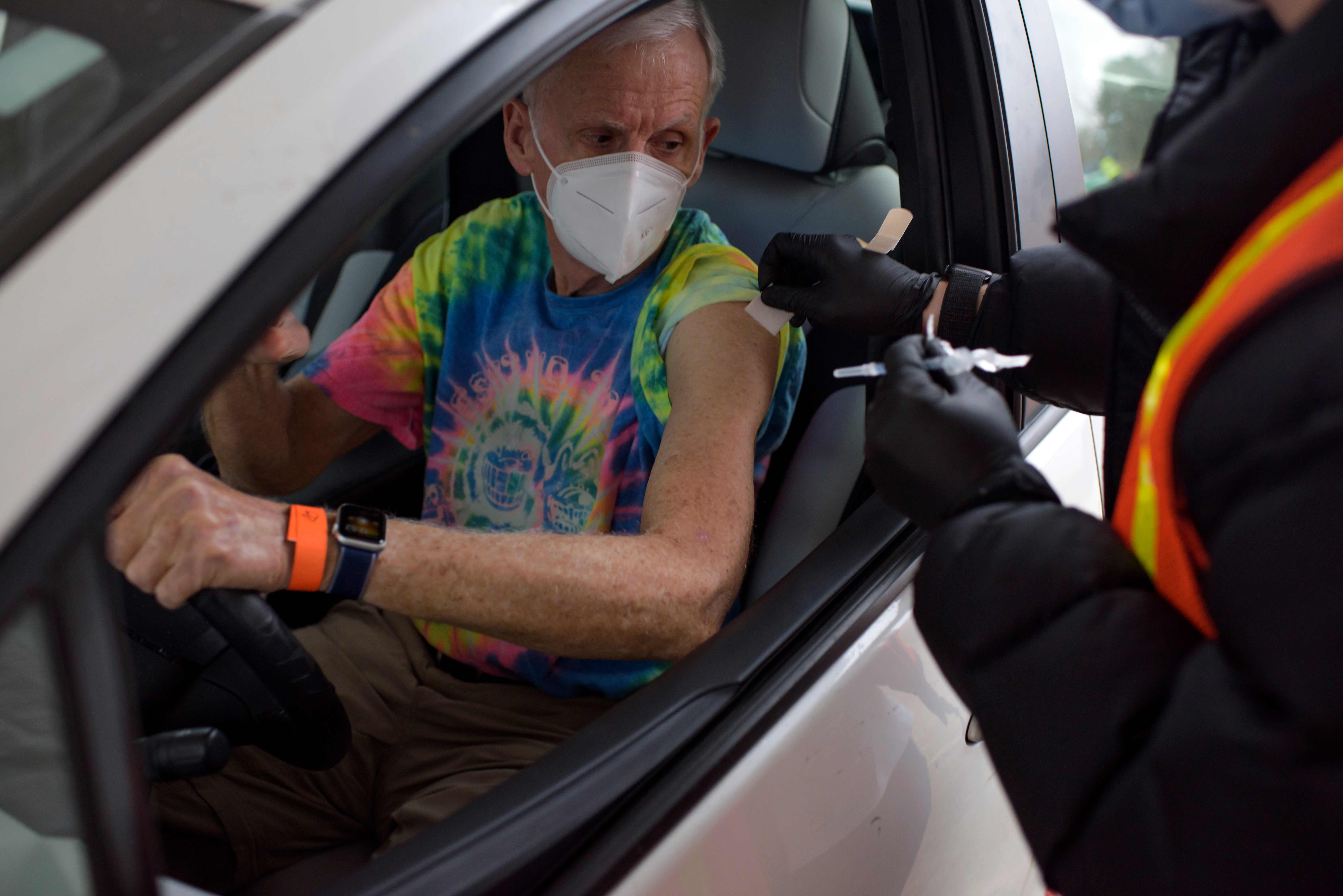 A man prepares to get his Covid-19 vaccine at a vaccination hub location in League City, Texas, February 5, 2021. (Photo by Mark Felix / AFP)
