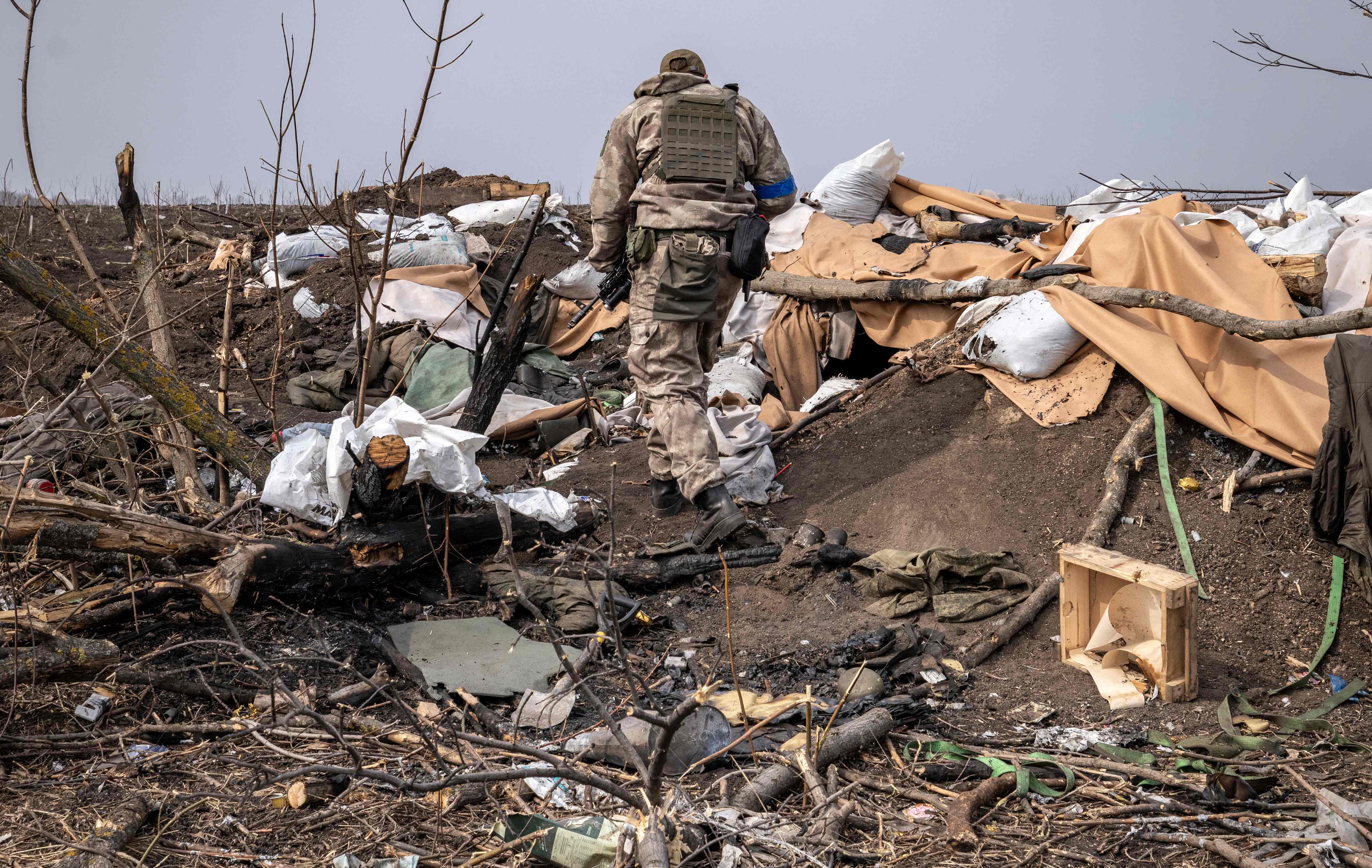 A Ukrainian soldier patrols near the village of Malaya Rohan, east of Kharkiv, on March 30, 2022. - Ukrainian forces on March 28, 2022 recaptured a small village on the outskirts of Ukraine's second-largest city Kharkiv, as Kyiv's forces mount counterattacks against a stalling Russian invasion. Members of the Ukrainian army were clearing and securing destroyed homes in the settlement of Malaya Rohan, about five kilometres (three miles) from Kharkiv, after pushing out Russian forces. (Photo by FADEL SENNA / AFP)
