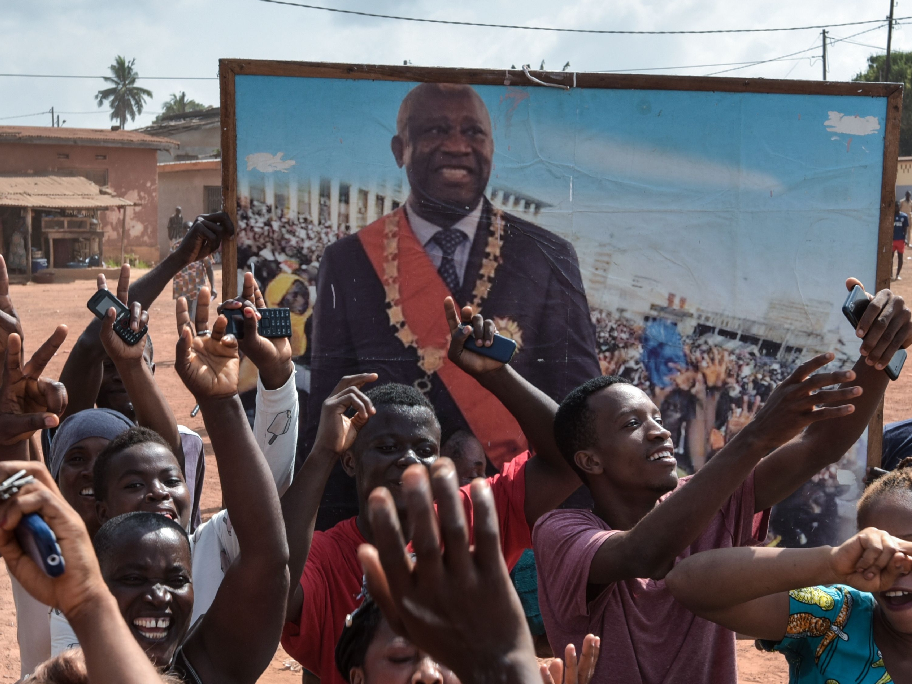 People celebrate in the streets of Divo, on January 15, 2019 after the International Criminal Court acquitted the former Ivory Coast president. - Judges ordered the immediate release of 73-year-old deposed strongman Laurent Gbagbo, the first head of state to stand trial at the troubled ICC, and his former youth leader Charles Ble Goude, 47. (Photo by Sia KAMBOU / AFP)